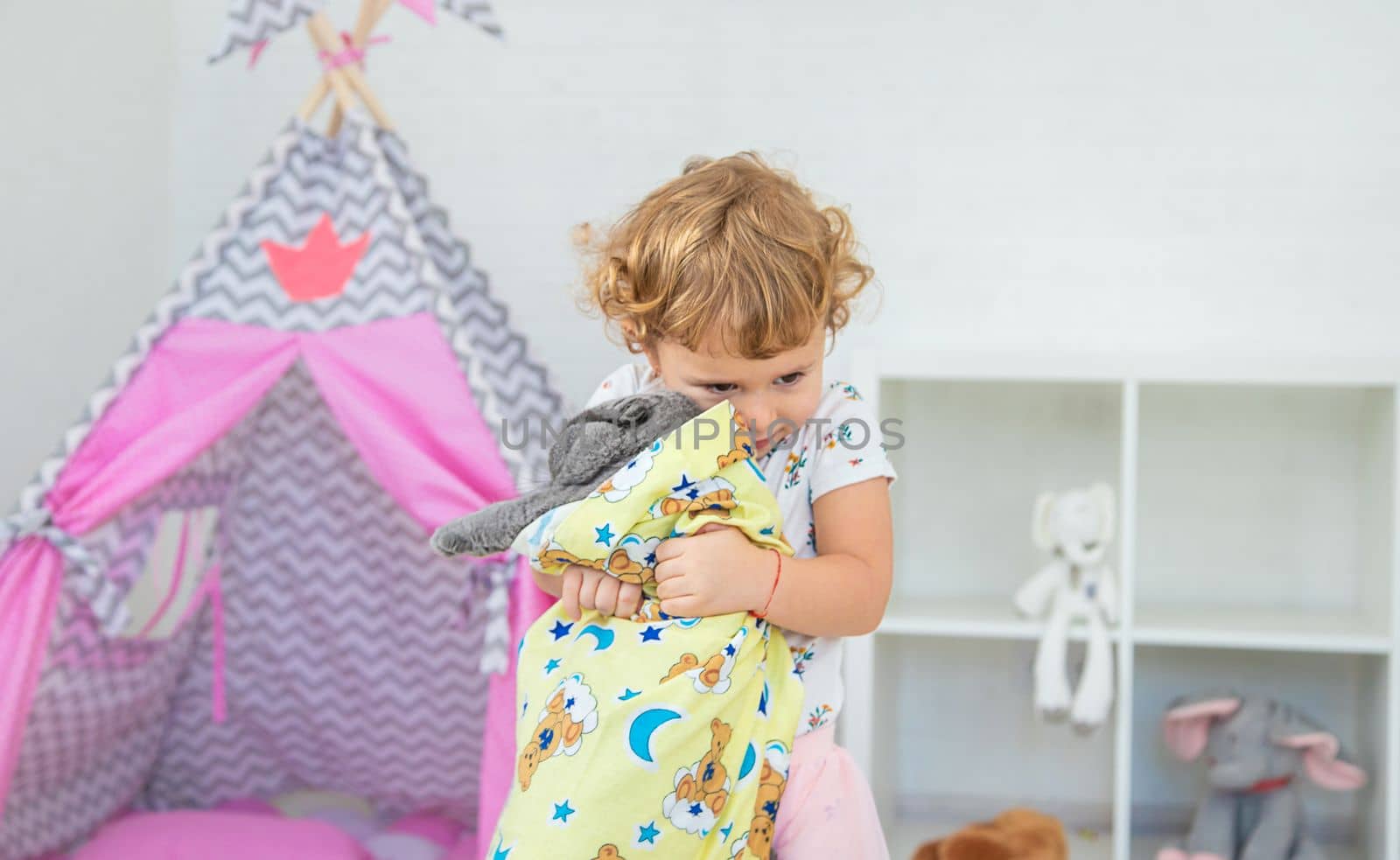 The child is playing with the cat. Selective focus. Kid.