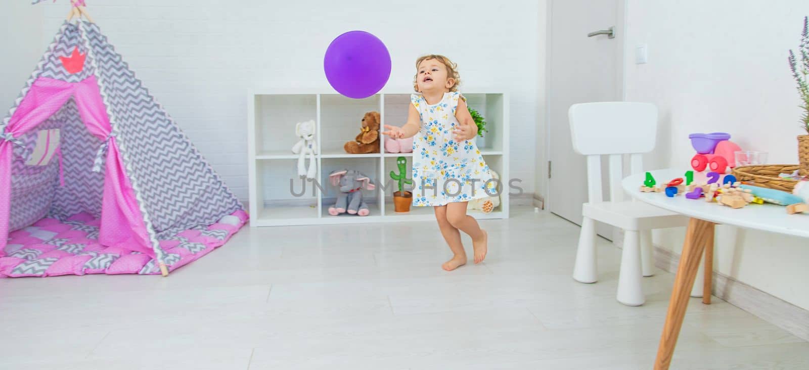 The child is playing with a balloon. Selective focus. Kid.