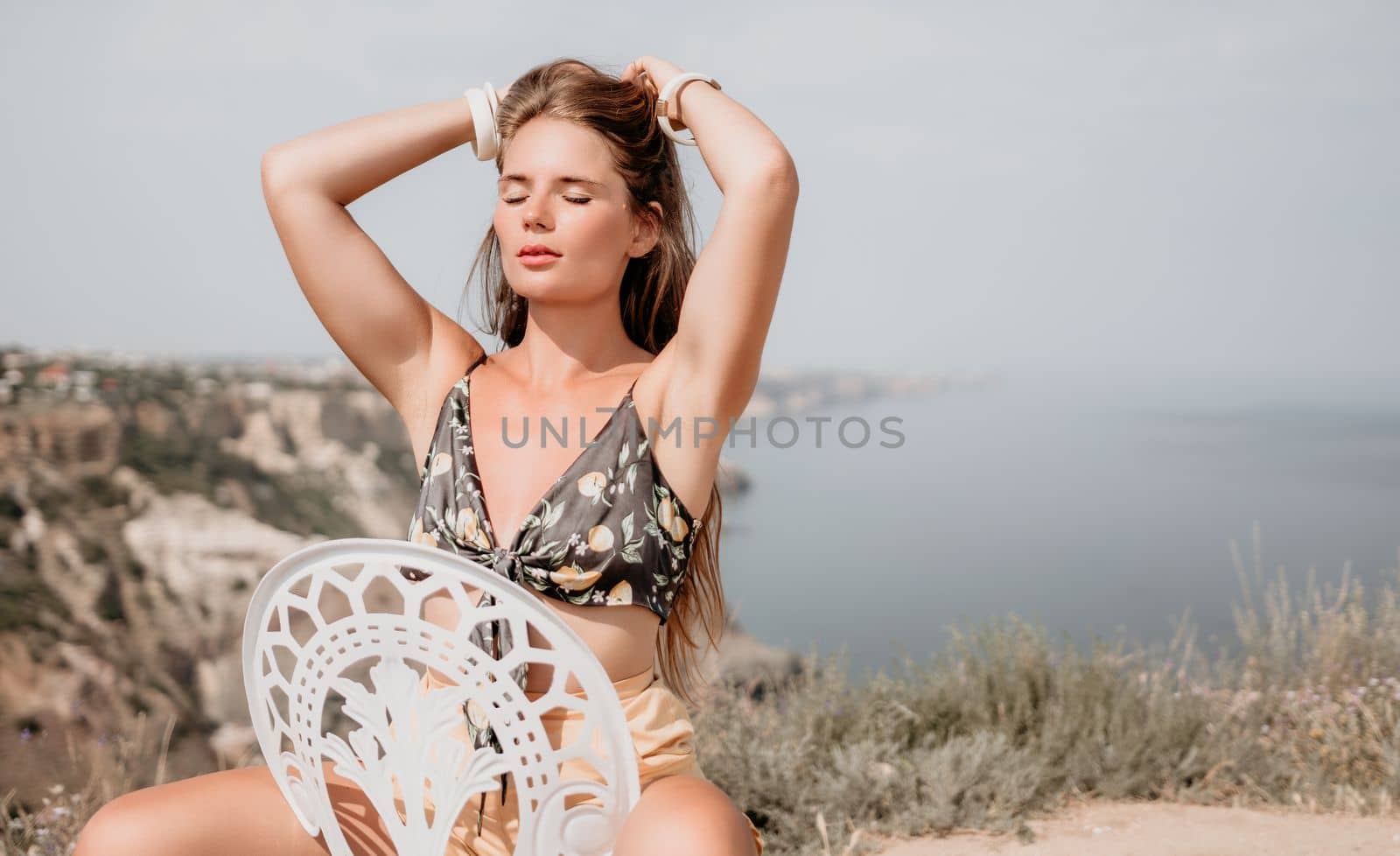 Happy boho woman portrait. Boho chic fashion style. Outdoor photo of free happy woman with long hair, sunny weather outdoors with sea mountains nature beautiful background. by panophotograph