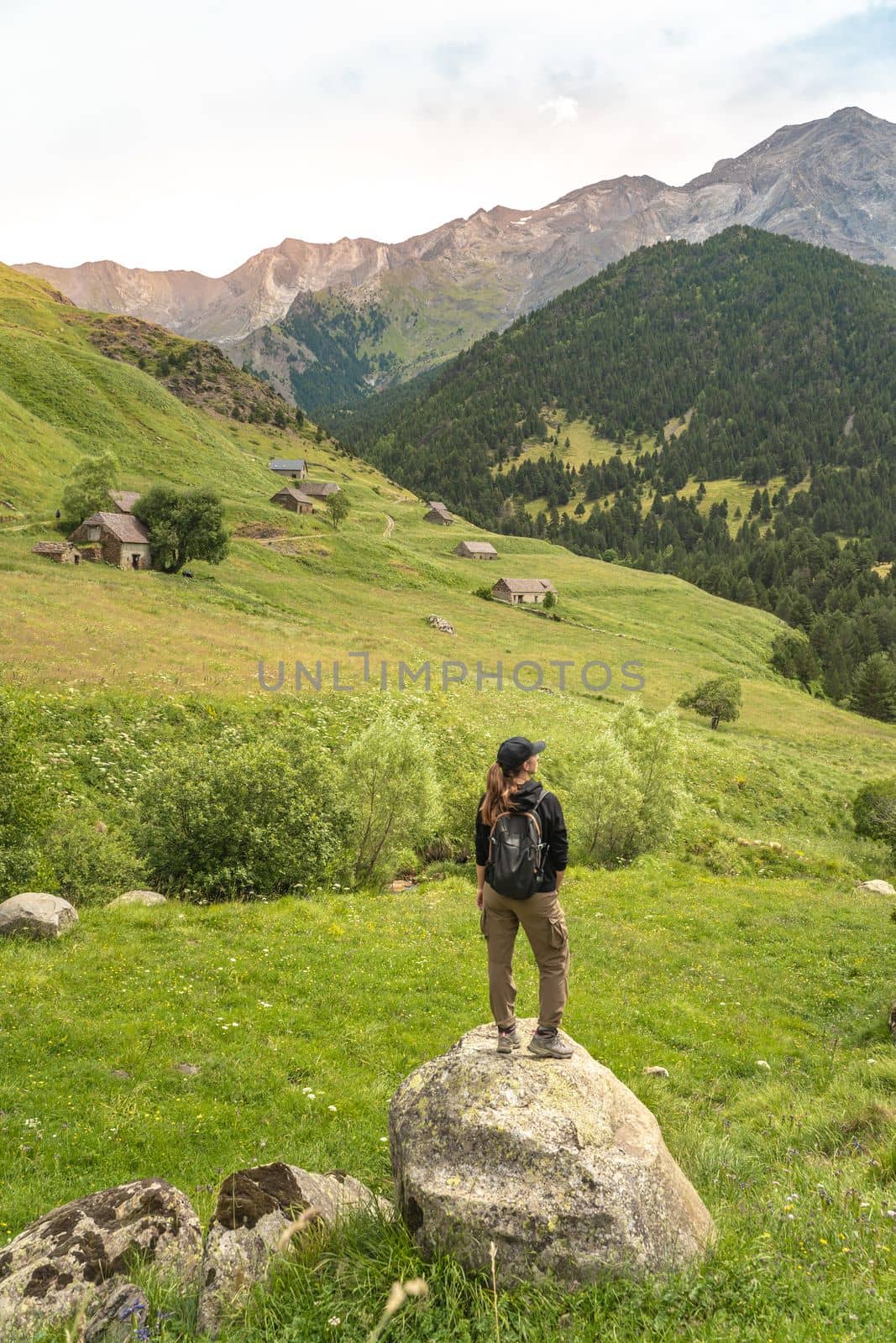 Young Woman With A Backpack on The Top Of a rock in a Beautiful wild Landscape. Discovery Travel Destination Concept. High quality photo