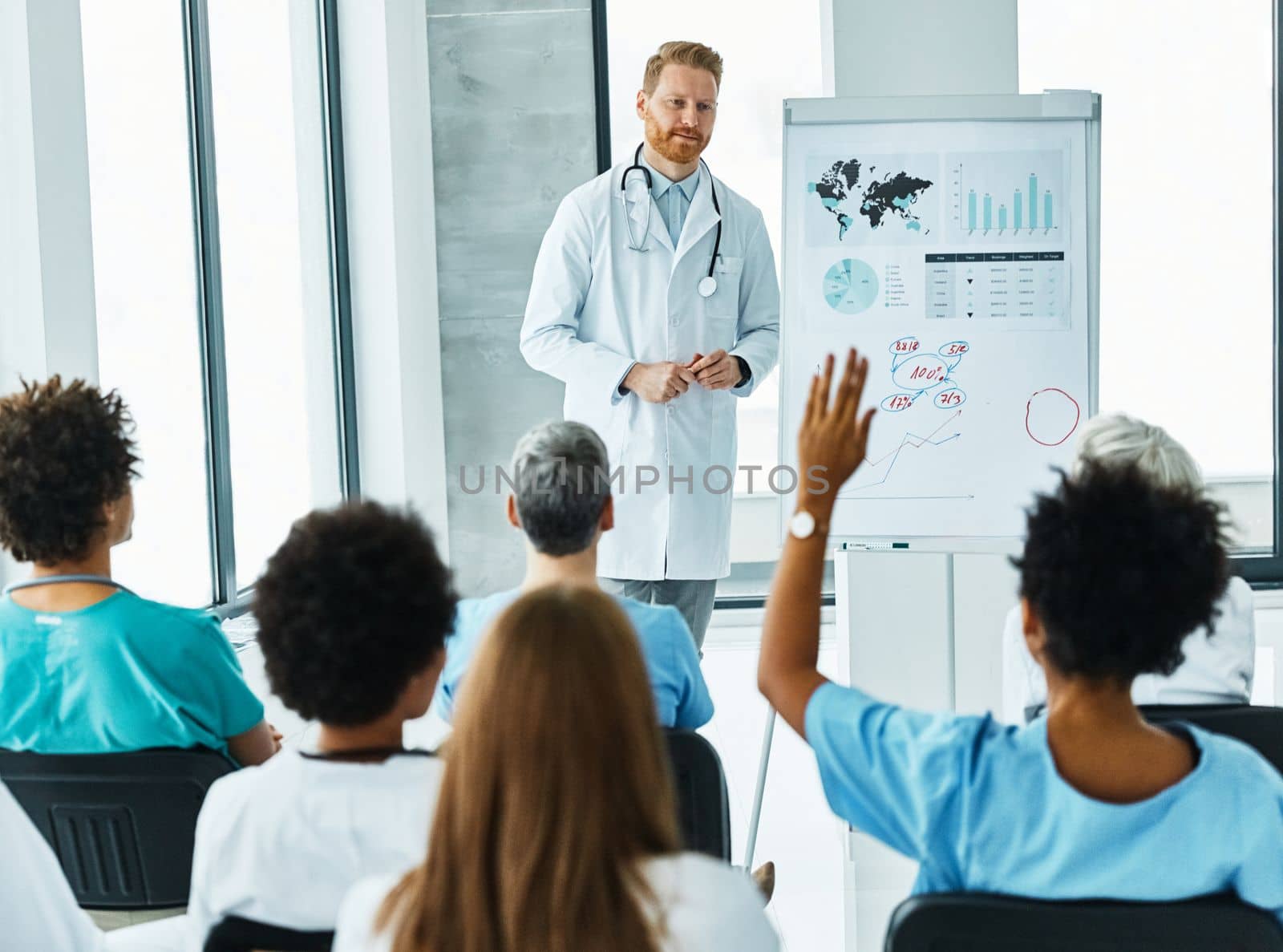 Portrait of a young doctor teaching on a seminar in a board room or during an educational class at convention center