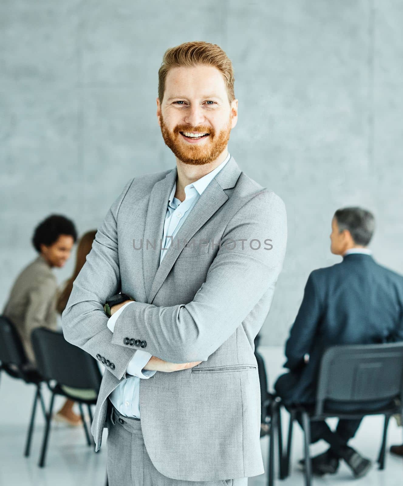 Portrait of a group of business people having a meeting in the office. Teamwork and success concept, portrait of a young businessman