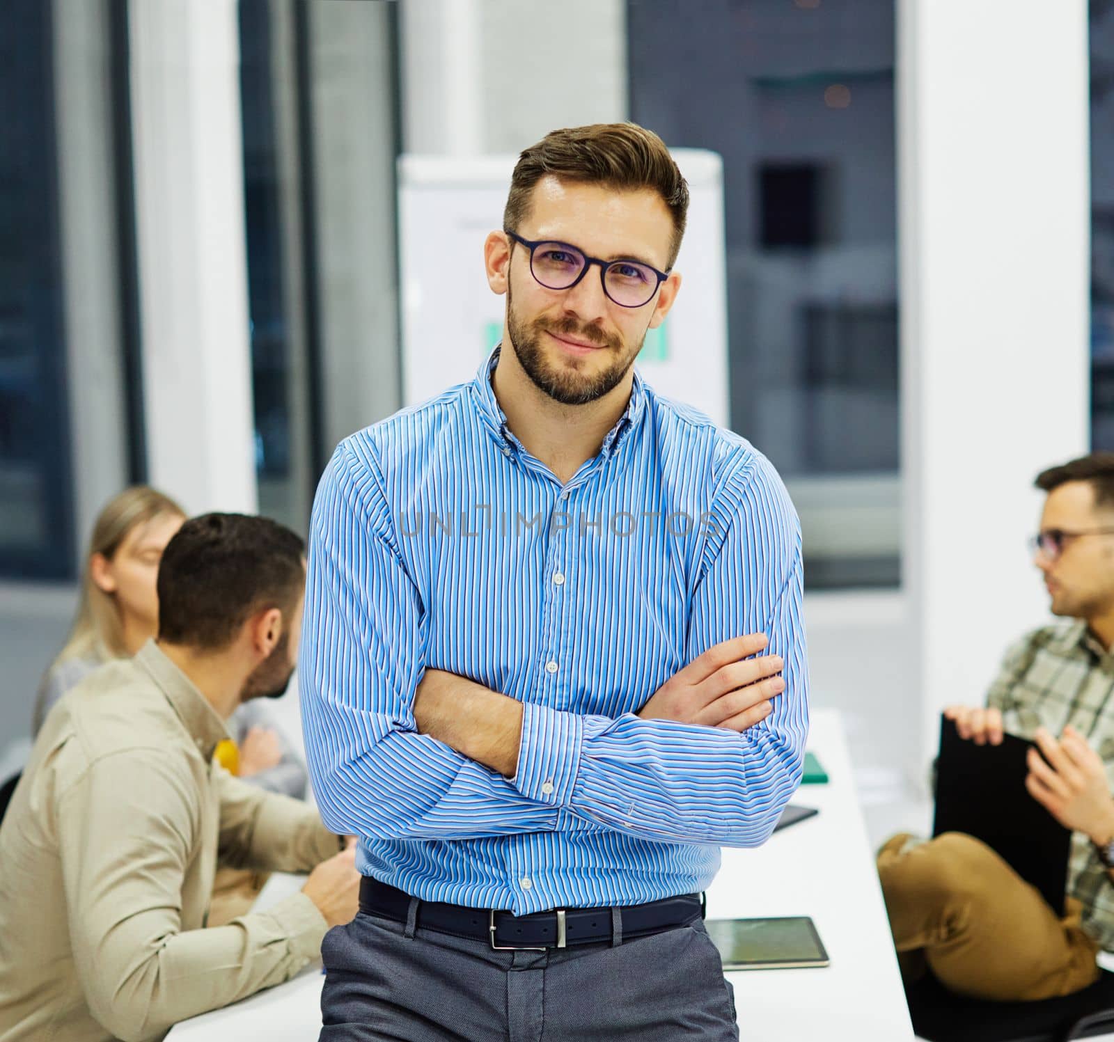 Portrait of a group of young business people having a meeting in the office. Teamwork and success concept, portrait of azoung businessman