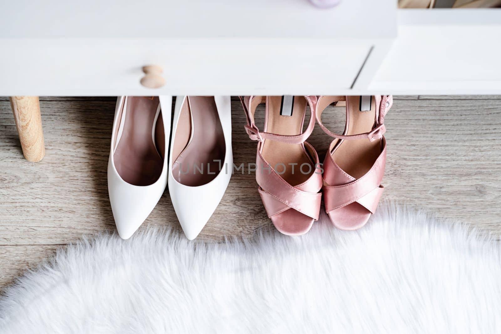 closeup of elegant high heel shoes standing under feminine dressing table by Desperada