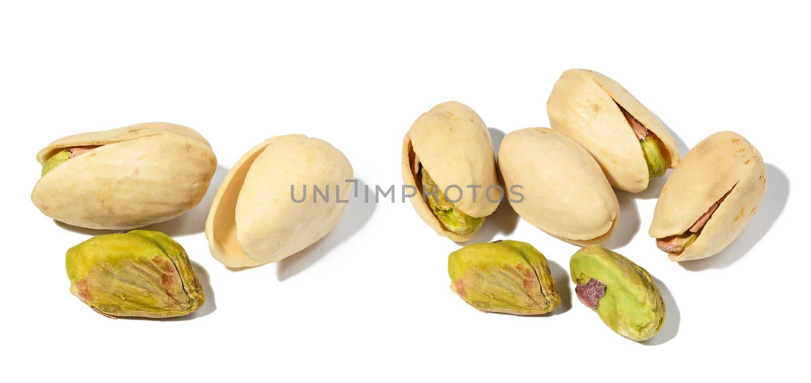 Salted open inshell pistachios isolated on a white background, tasty and healthy snack, close up. Set