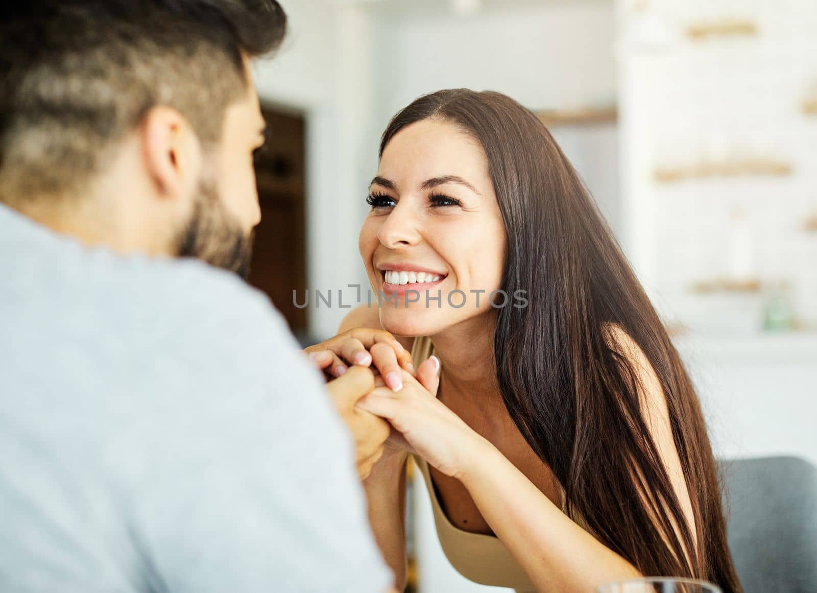 Portrait of a young woman talking to a boyfriend at home or in a restaurant