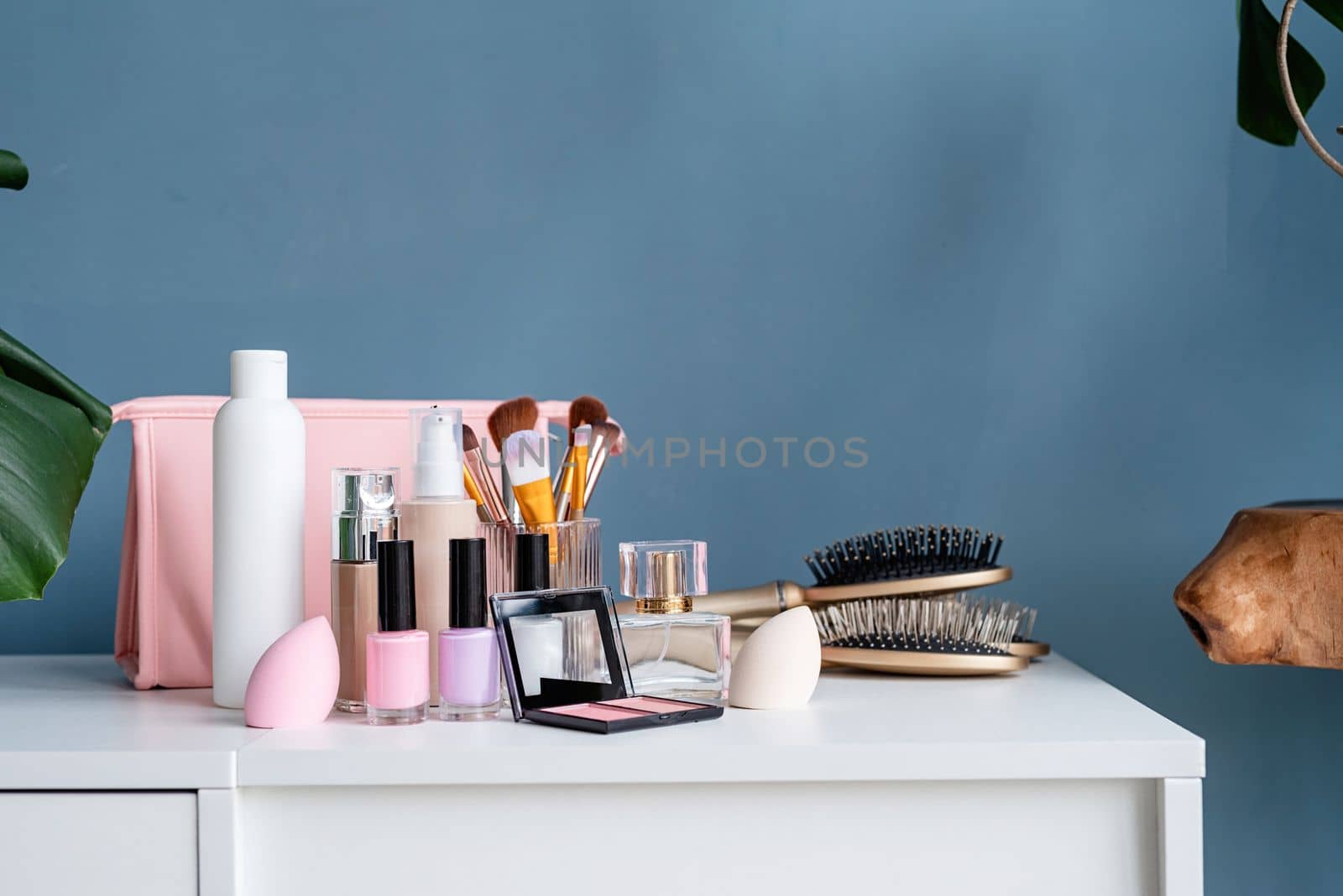 closeup of feminine cosmetic products standing on dressing table by Desperada