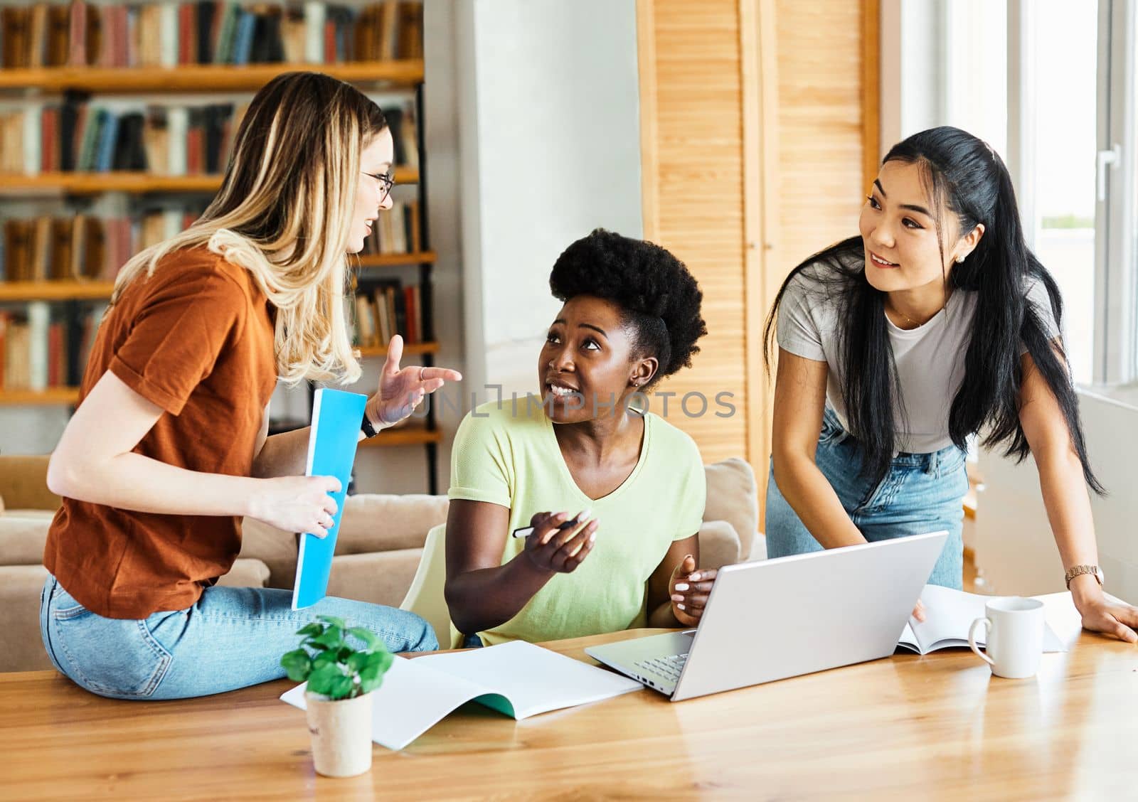 Portrait of a young happy girls using laptop at home or in the office