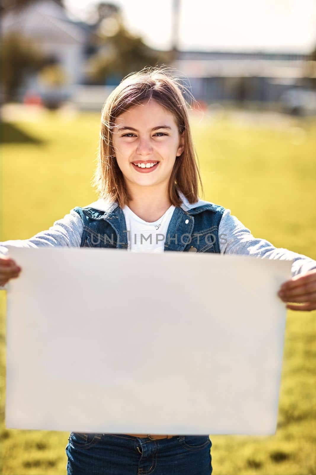 Have you seen this. Portrait of a little girl holding a blank board outdoors