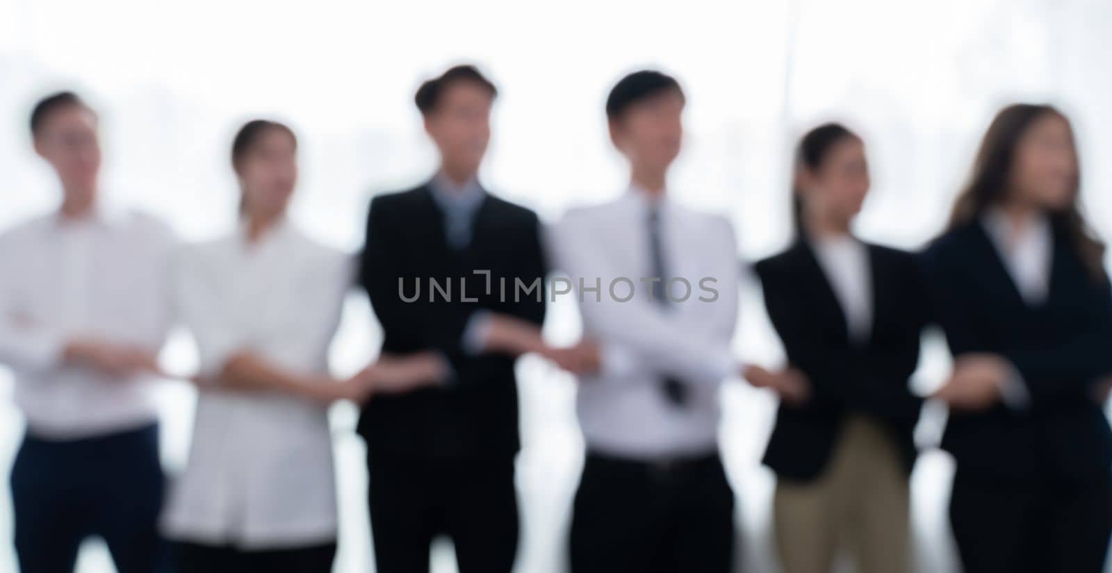 Blurred image of businesspeople holding hand in line as office of harmony. by biancoblue