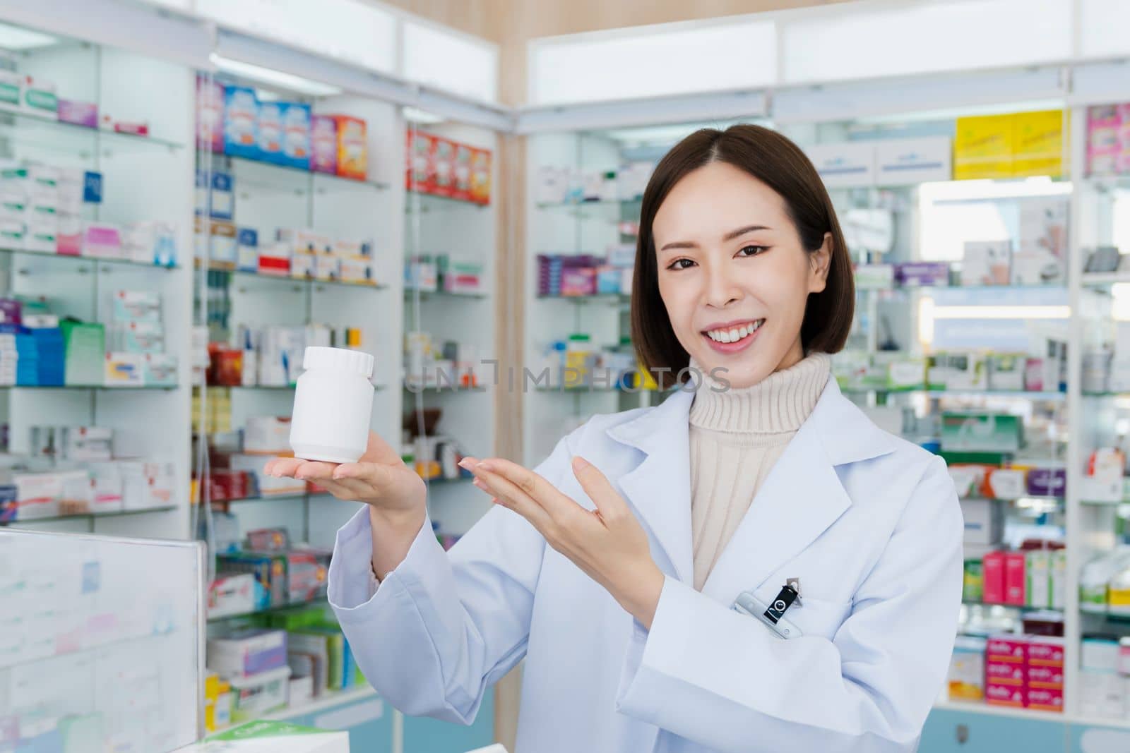 Portrait of young asian pharmacist pill bottle mockup at qualified pharmacy by biancoblue