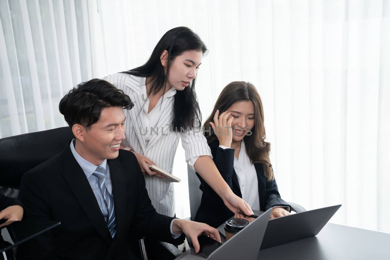 Harmony in office concept as business people analyzing dashboard paper together in workplace. Young colleagues give ideas at manager desk for discussion or strategy planning about project.