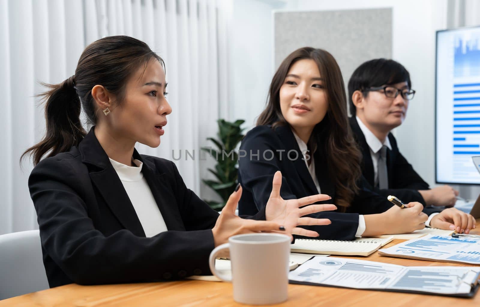 Business team of financial data analysis meeting with business intelligence, report paper and dashboard on laptop for marketing strategy. Business people working together to promote harmony in office.