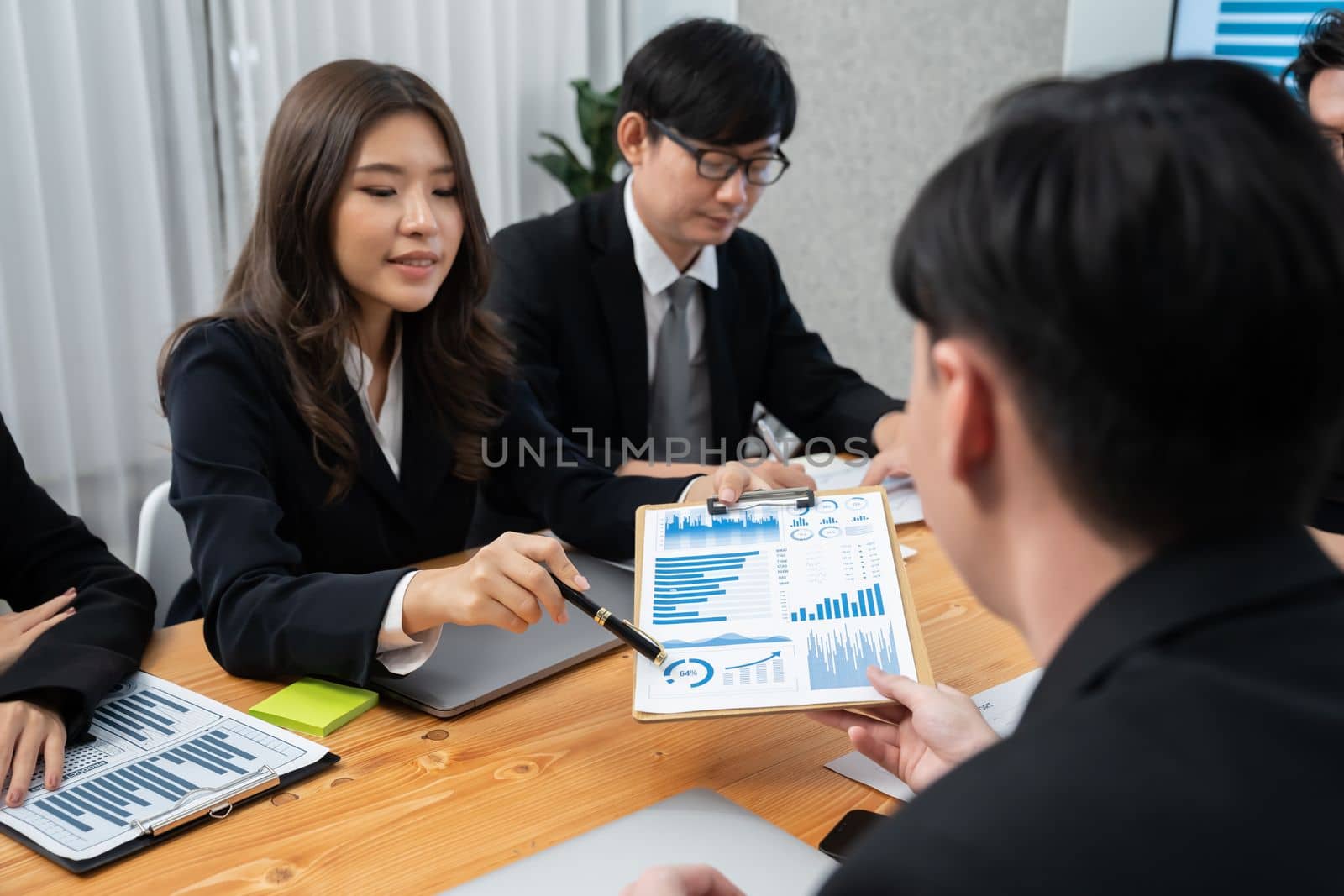 Business team of financial data analysis meeting with business intelligence, report paper and dashboard on laptop for marketing strategy. Business people working together to promote harmony in office.