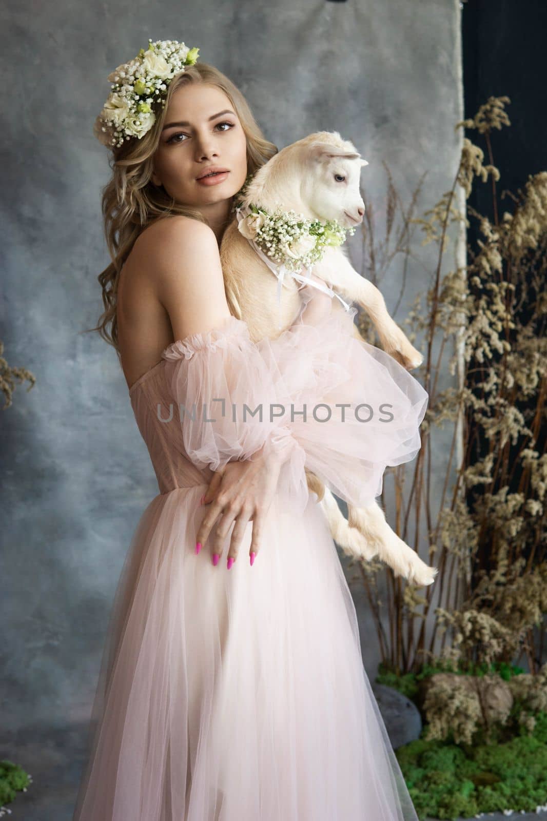 A young blonde woman in an airy pink dress with a white kid. Spring portrait of a woman. by Annu1tochka