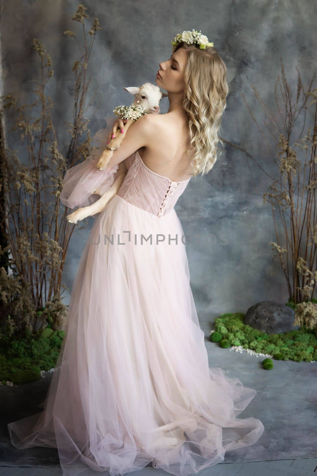 A young blonde woman in an airy pink dress with a white kid. Spring portrait of a woman. by Annu1tochka