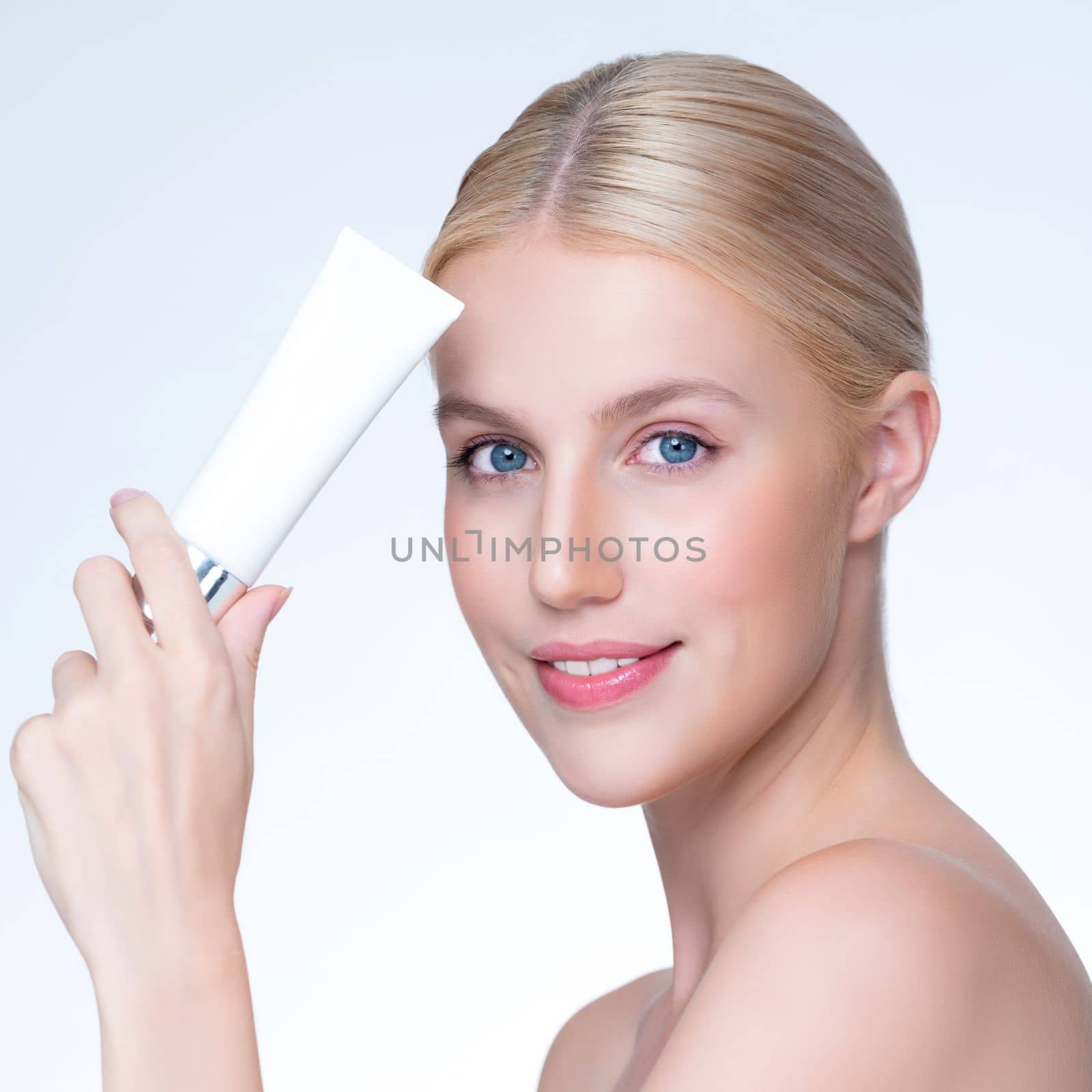Closeup personable beautiful perfect natural skin woman hold mockup tube moisturizer cream for skincare treatment product advertising expressive facial and gesture expression in isolated background.