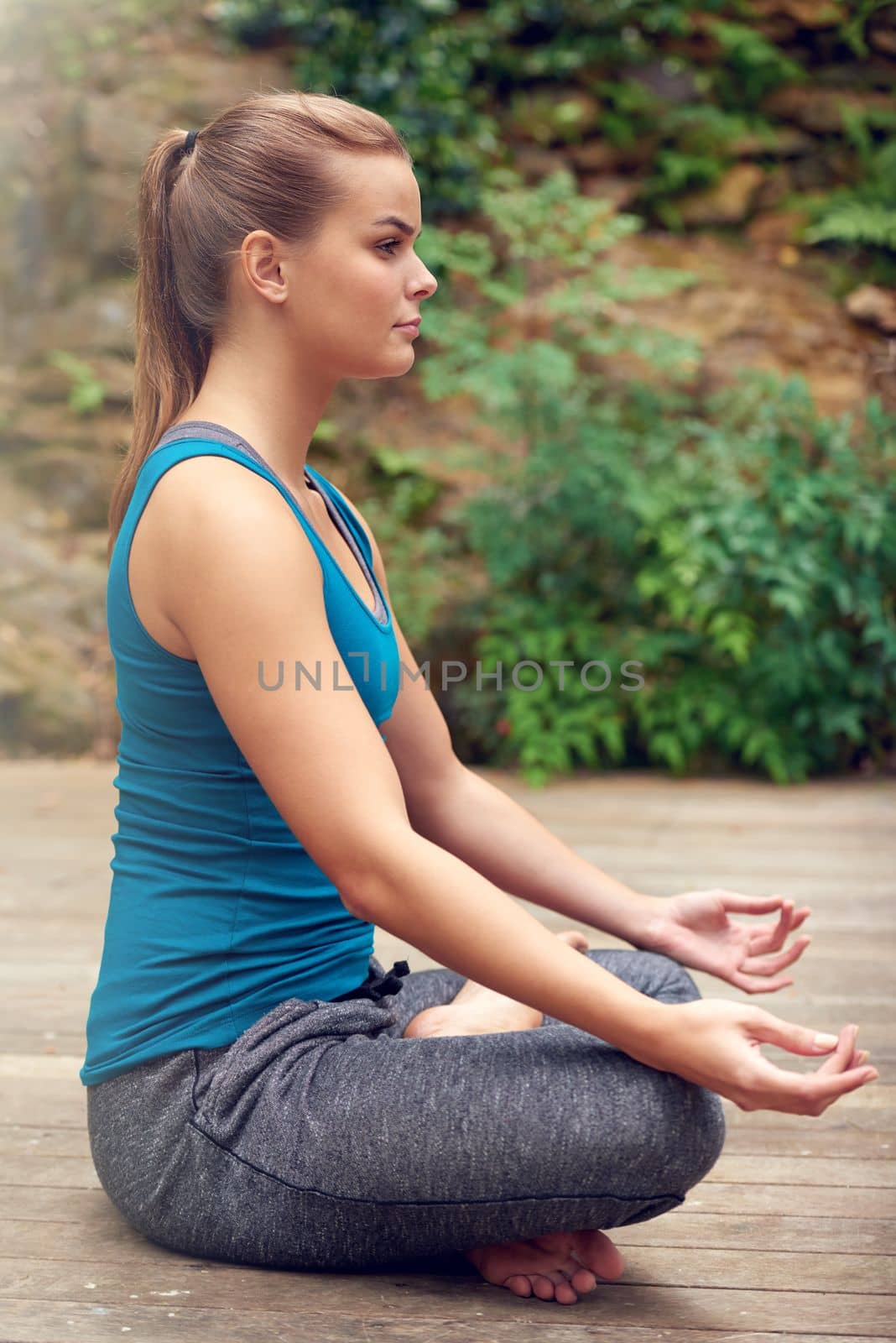 Peace is all I need. a young woman practicing yoga outdoors