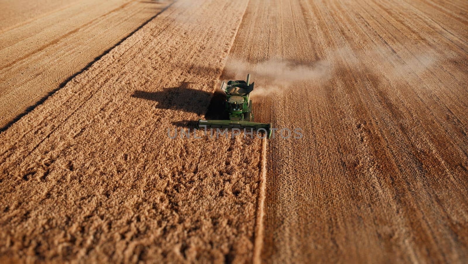John Deere harvester works in the field. Combine Harvesting Wheat. Field field of cereals during harvesting. Modern equipment works. 07.07.22, Rostov region, Russia.