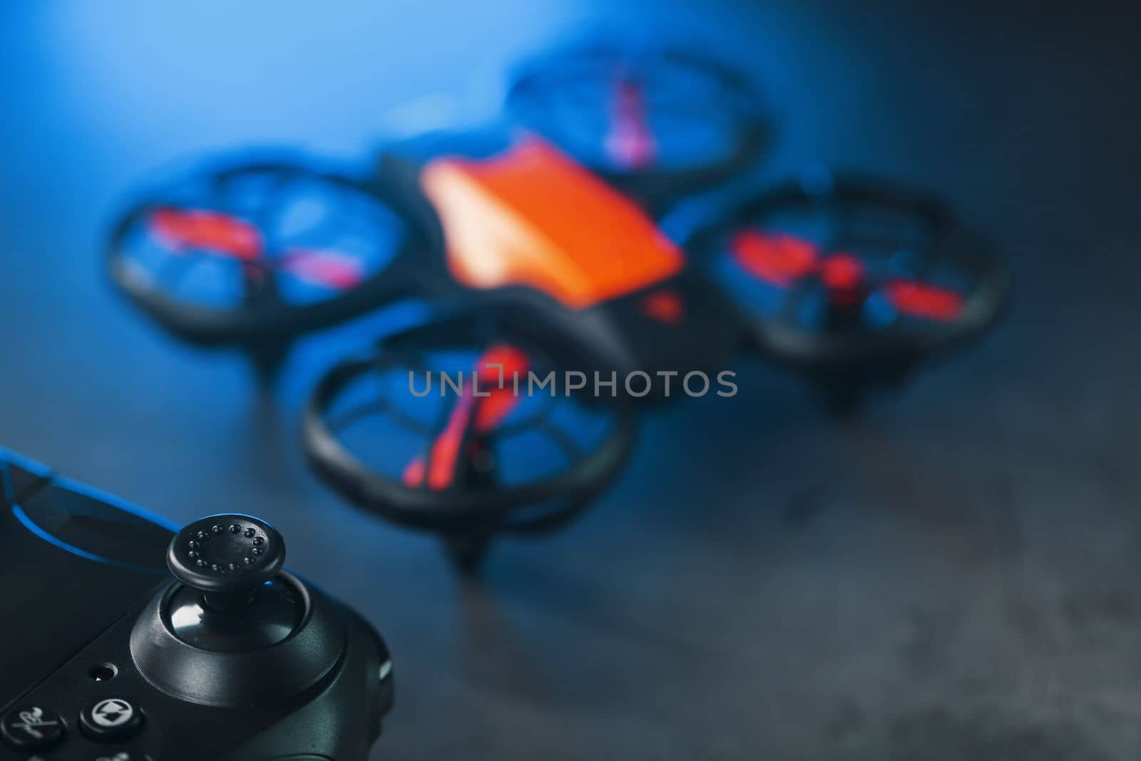 A reconnaissance quadcopter drone with an orange body a by AlexGrec
