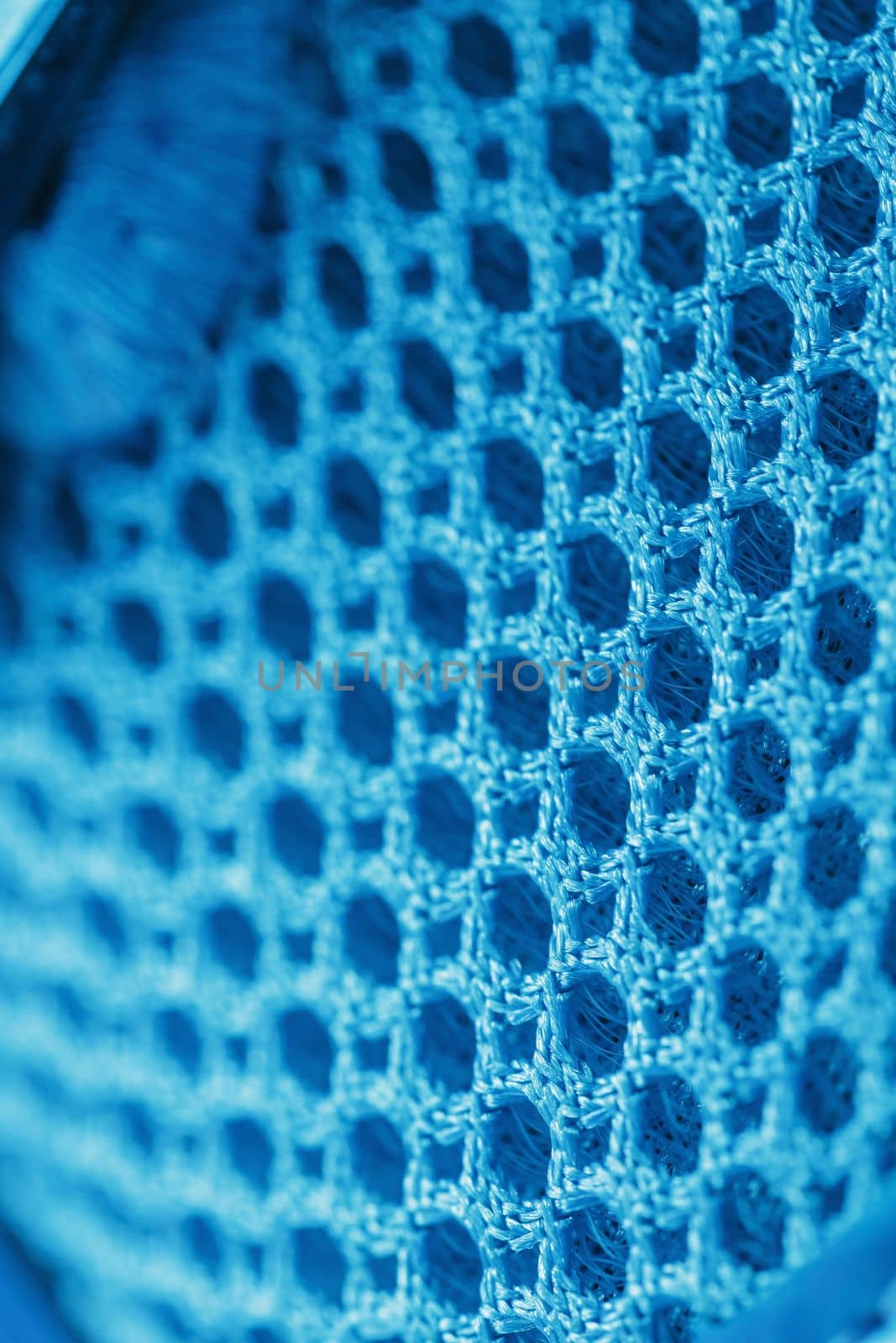 Macro Ventilation grid of blue sneakers in full screen.