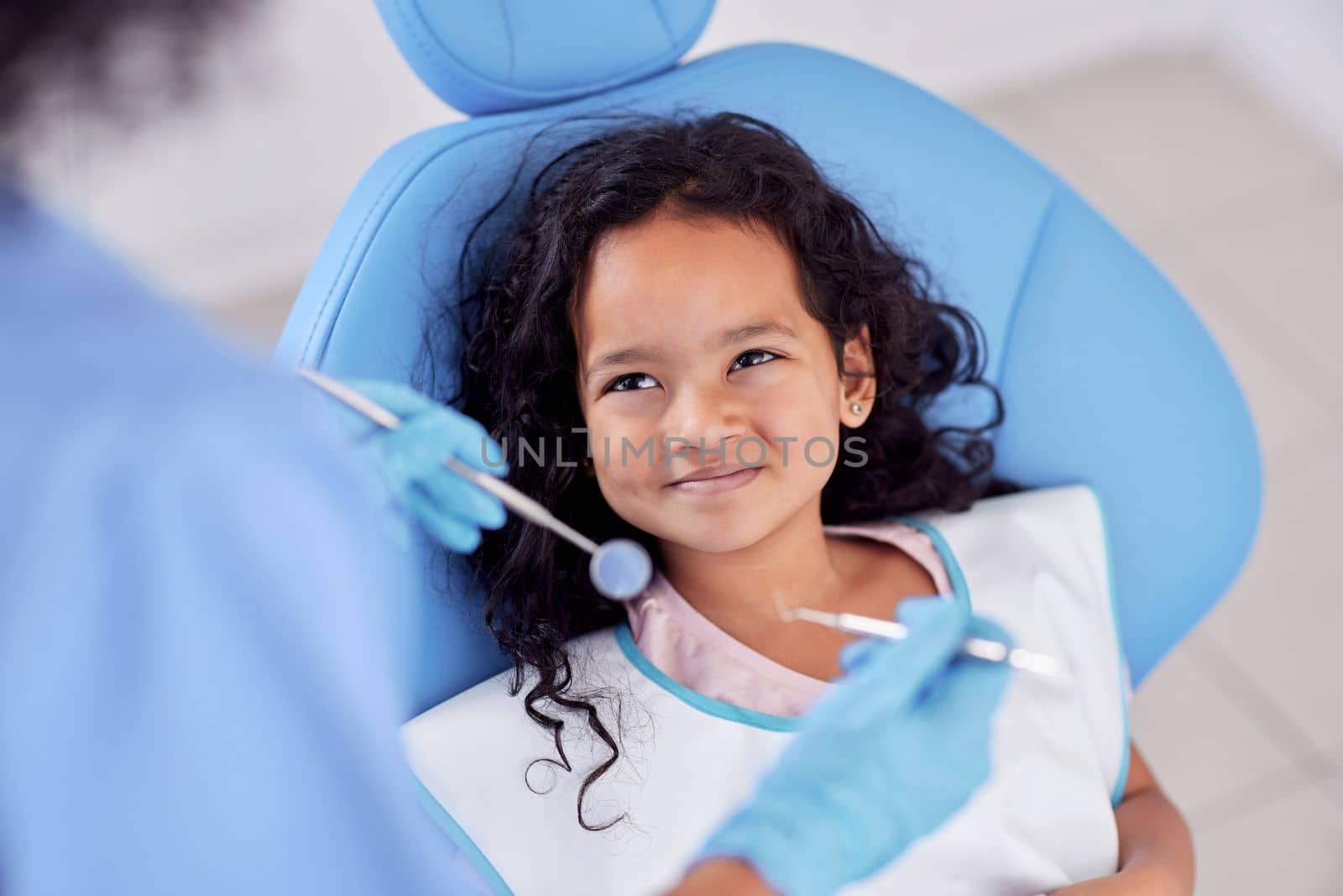 Well give you a smile thats brighter than before. an adorable little girl having dental work done on her teeth. by YuriArcurs