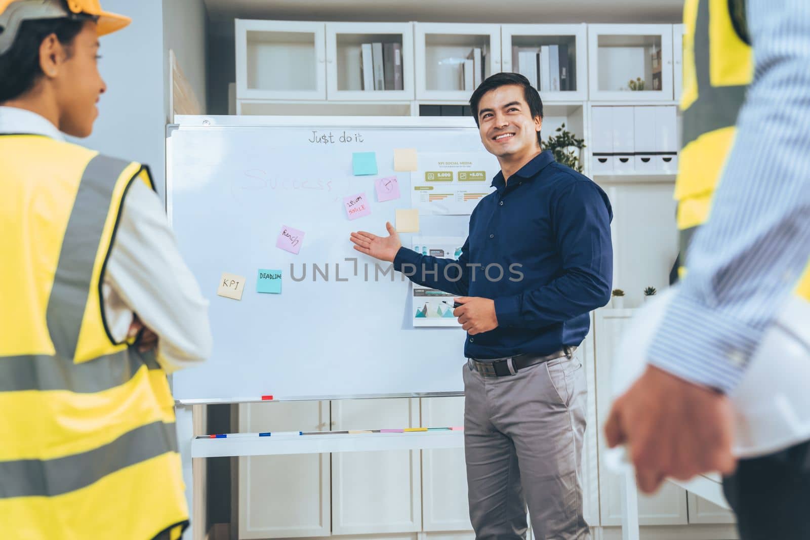 Entrepreneur brainstorming ideas with his competent engineers in the office. Architectural investors and engineers working on an upcoming project in a fun and friendly environment.