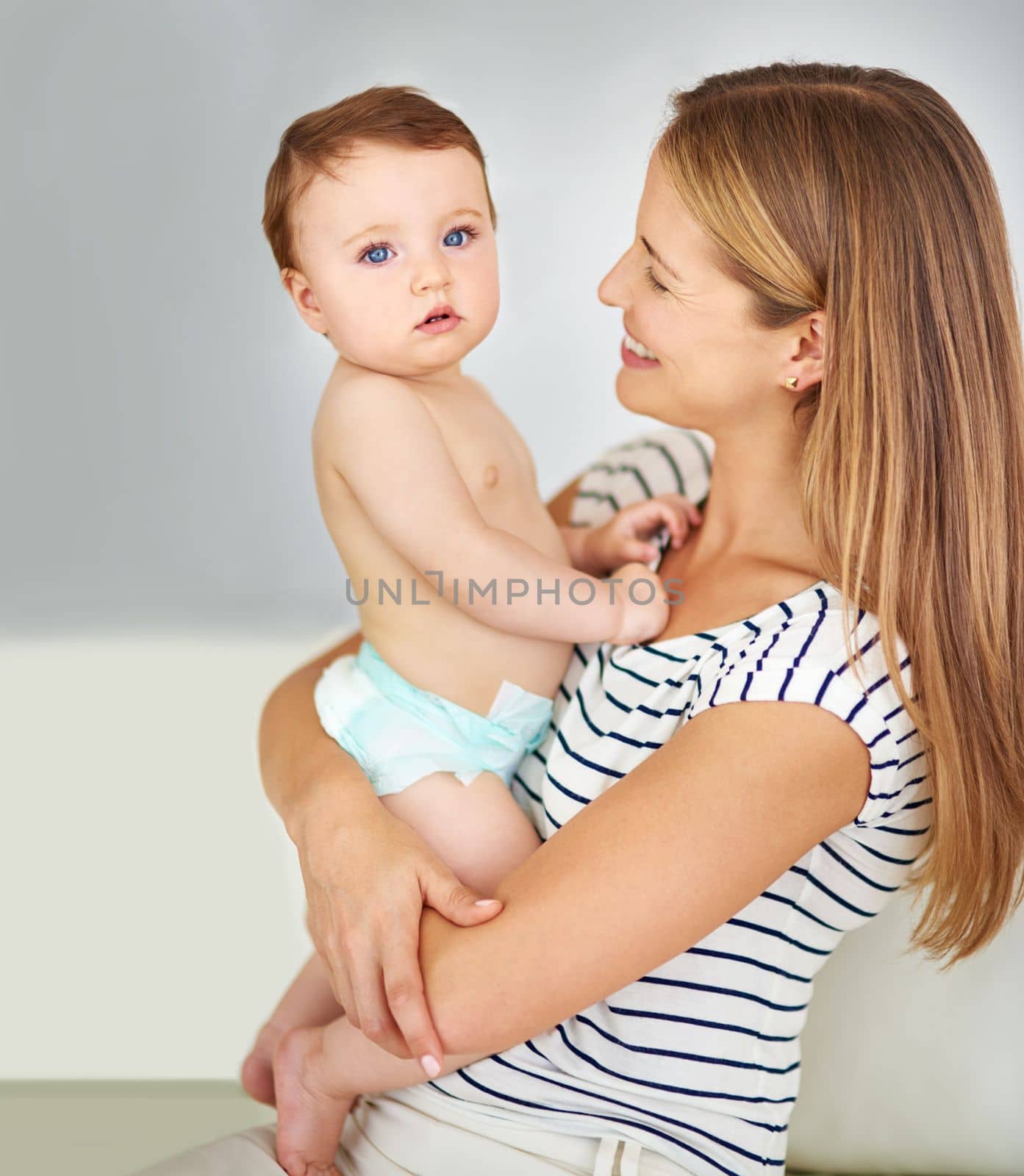 Motherly love at its best. a mother carrying her adorable baby girl