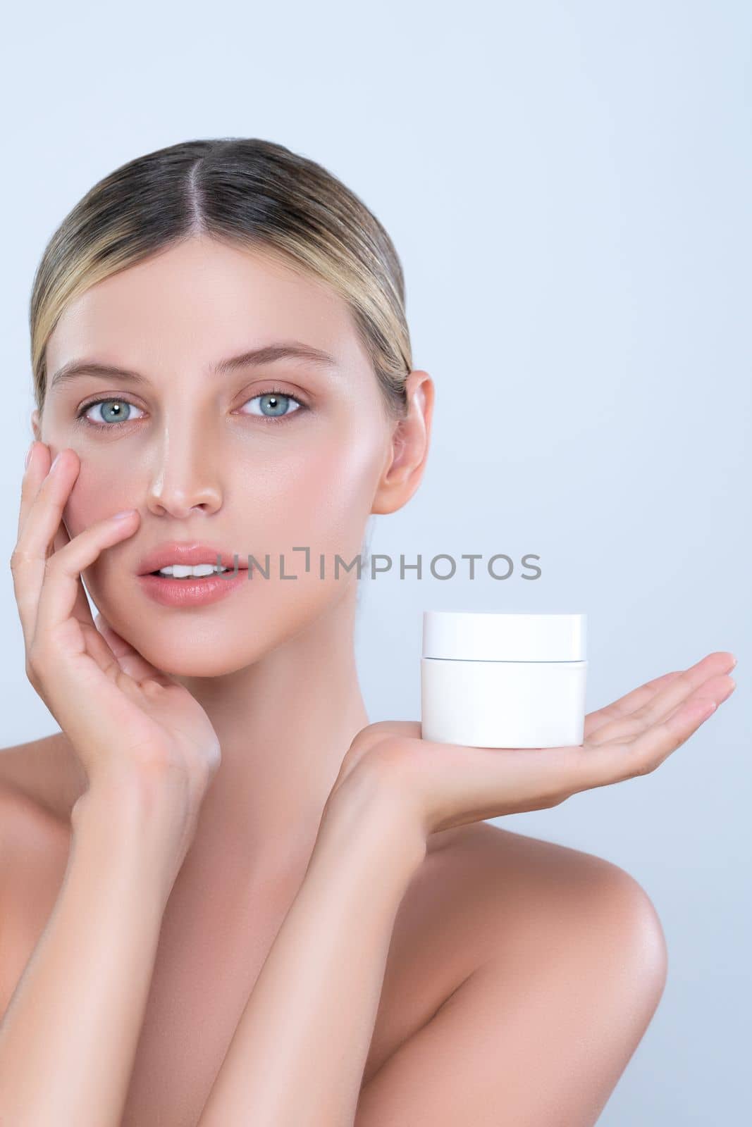 Alluring portrait of perfect skin woman holding mockup moisturizer jar. by biancoblue