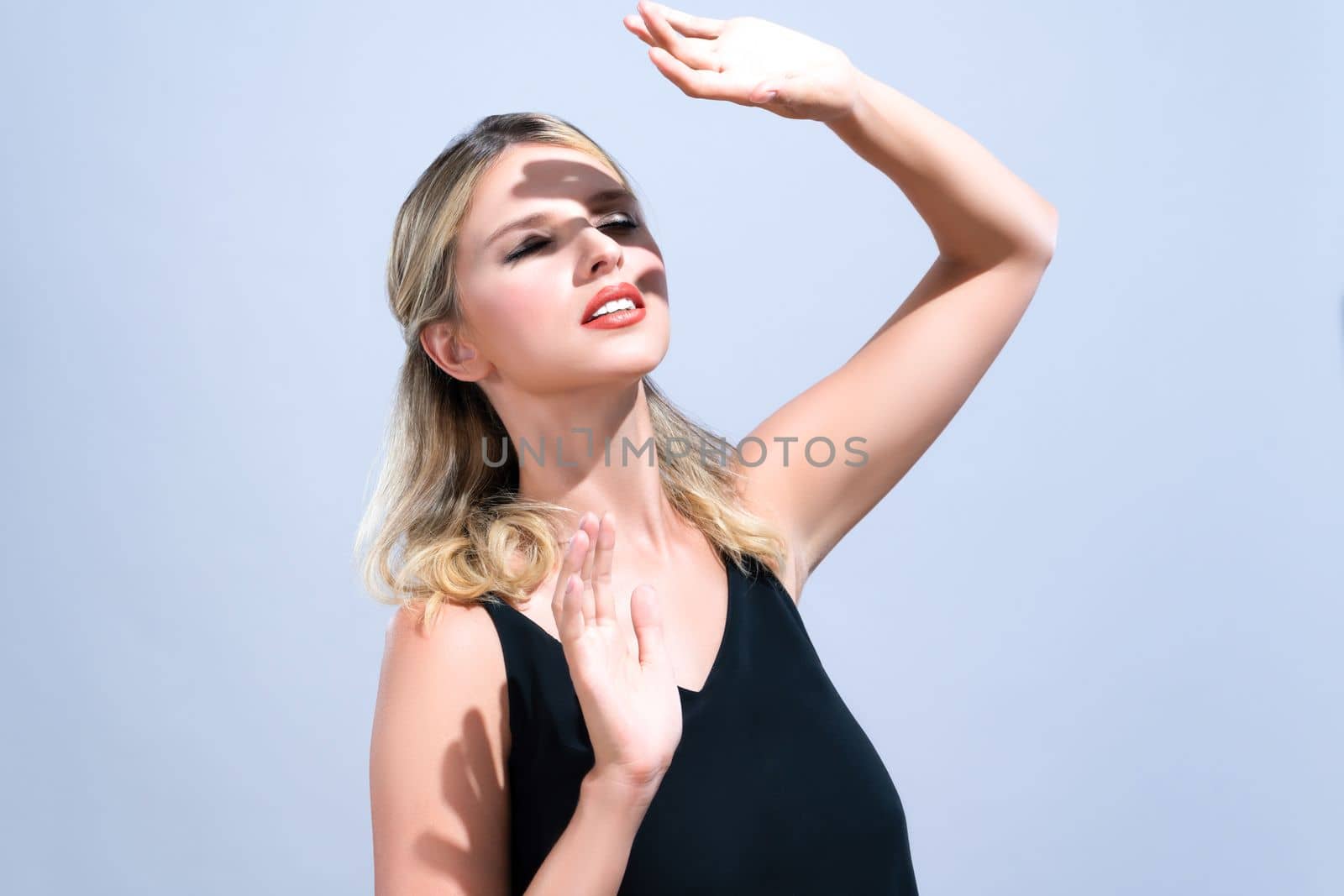Closeup young woman with alluring soft makeup cover face with hand. by biancoblue