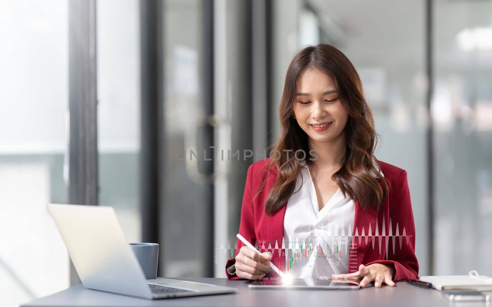 Asian Businesswoman Using laptop and tablet working at office with document on desk, doing planning analyzing the financial report, business plan investment, finance analysis concept by nateemee