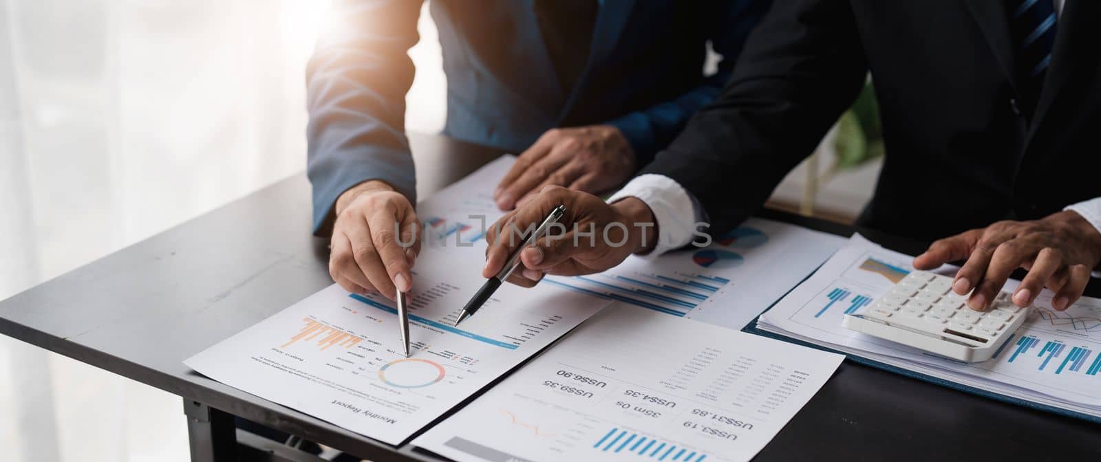 Business People Meeting using laptop computer,calculator,notebook,stock market chart paper for analysis Plans to improve quality next month. Conference Discussion Corporate Concept....
