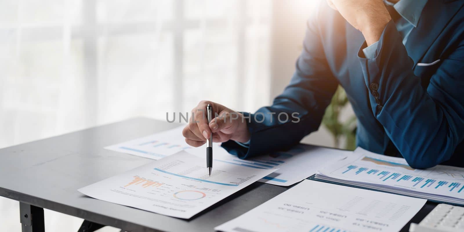 Close up Businessman using calculator and laptop for calculating finance, tax, accounting, statistics and analytic research concept by wichayada