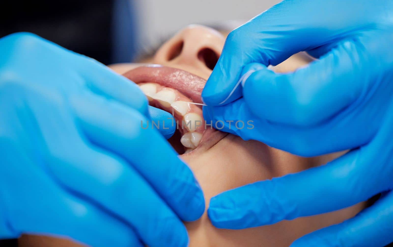 No space goes un-missed. a young woman having a dental procedure performed on her