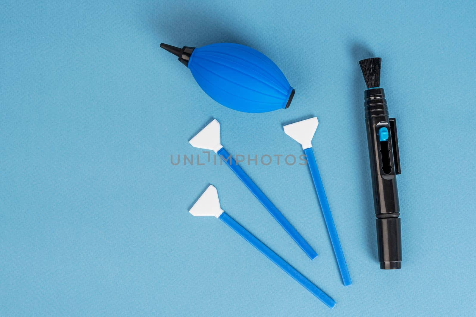 a set for cleaning the chamber from dirt. a purge bag, a mop for cleaning the matrix, a cleaning liquid. blue background