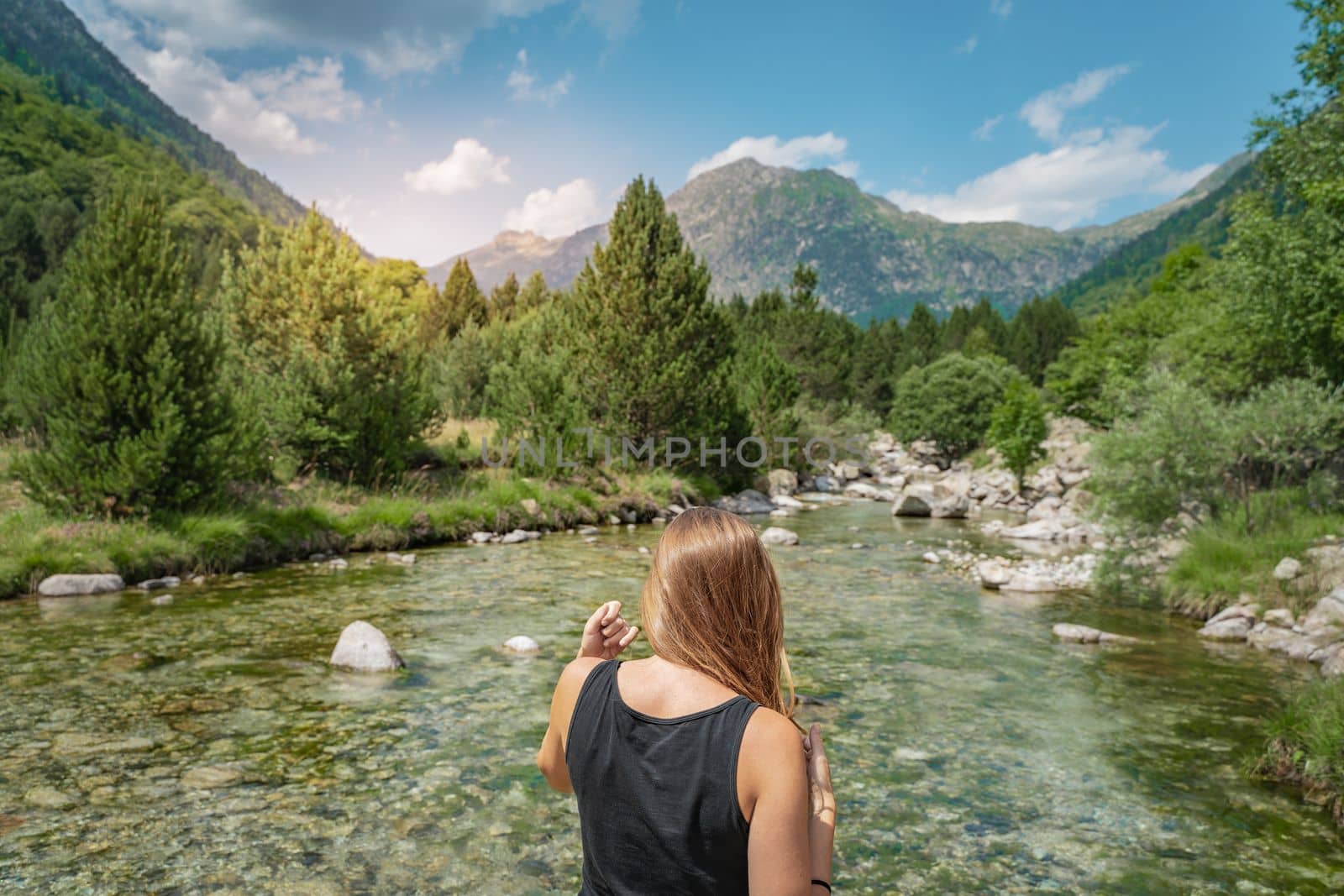 Young Woman hiking in a beautiful river between mountains during the sunset. Discovery Travel Destination Concept High quality photo