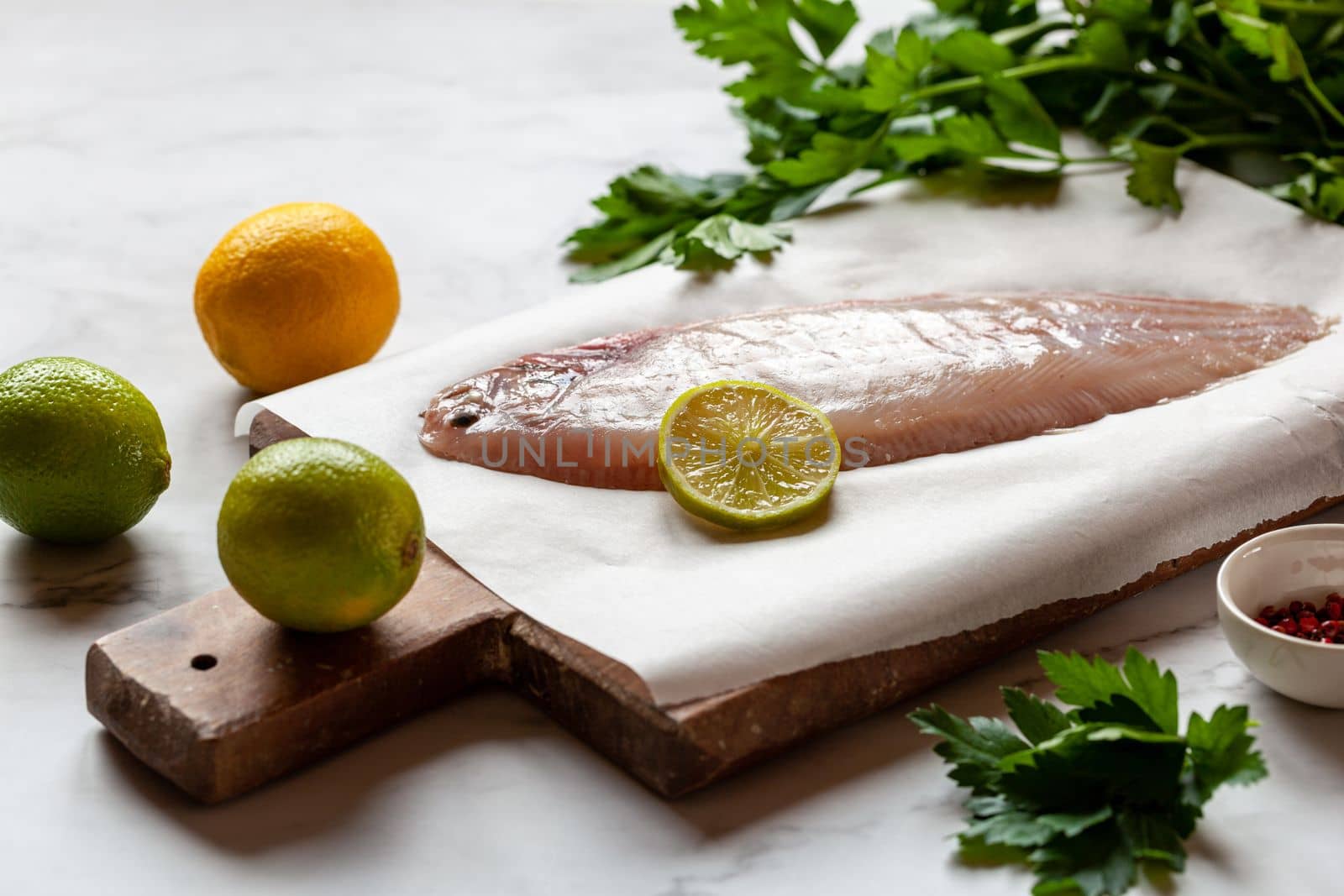 cooking of the sole flatfish meuniere style, raw fish and other ingredients on the table