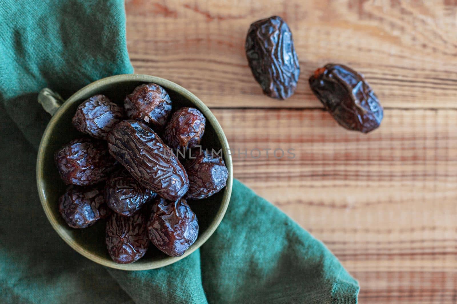 dates fruits in a bowl, top view, copy space