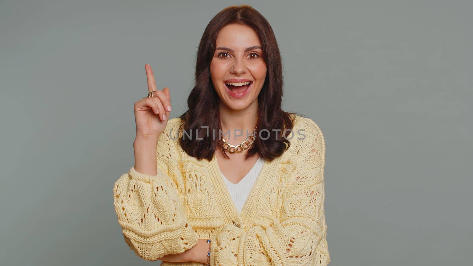 Eureka. Inspired pretty woman pointing finger up with open mouth, having good idea, plan, startup, showing inspiration motivation gesture, problem solution. Young girl isolated on gray background