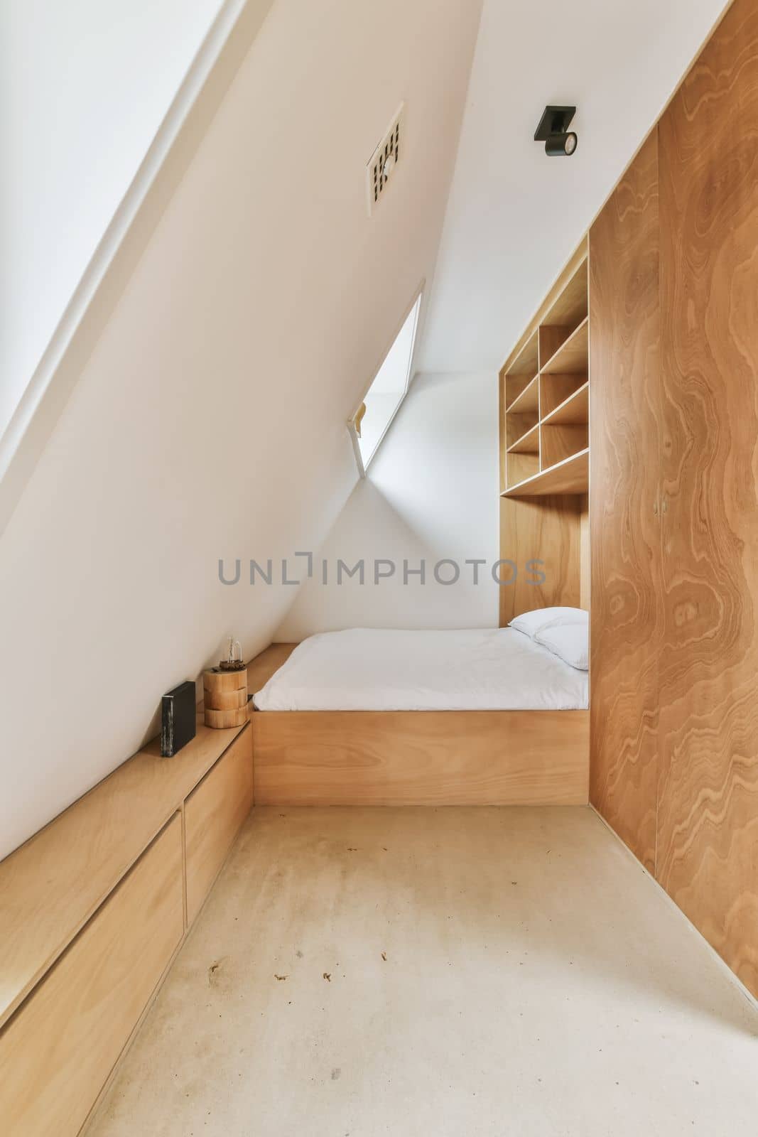 an attic bedroom with wood furniture and built in the wall to make it look like a modern home or office