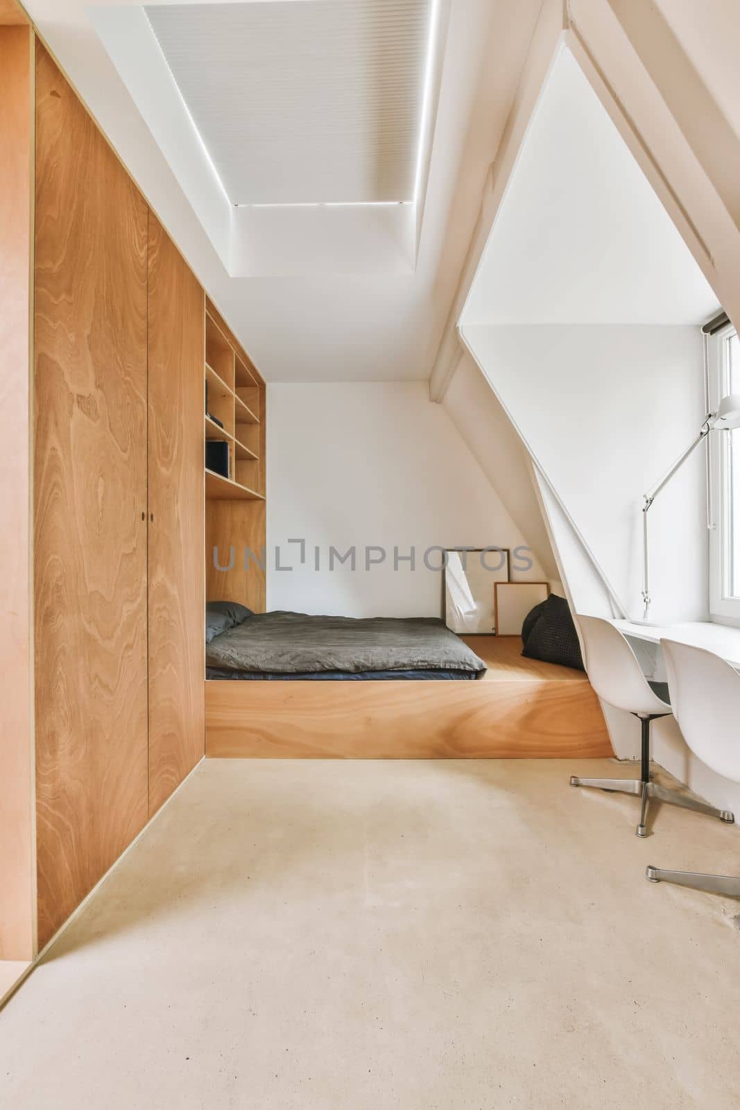 a bedroom with a bed, desk and shelves on the wall next to an open closet in a room that has been used for