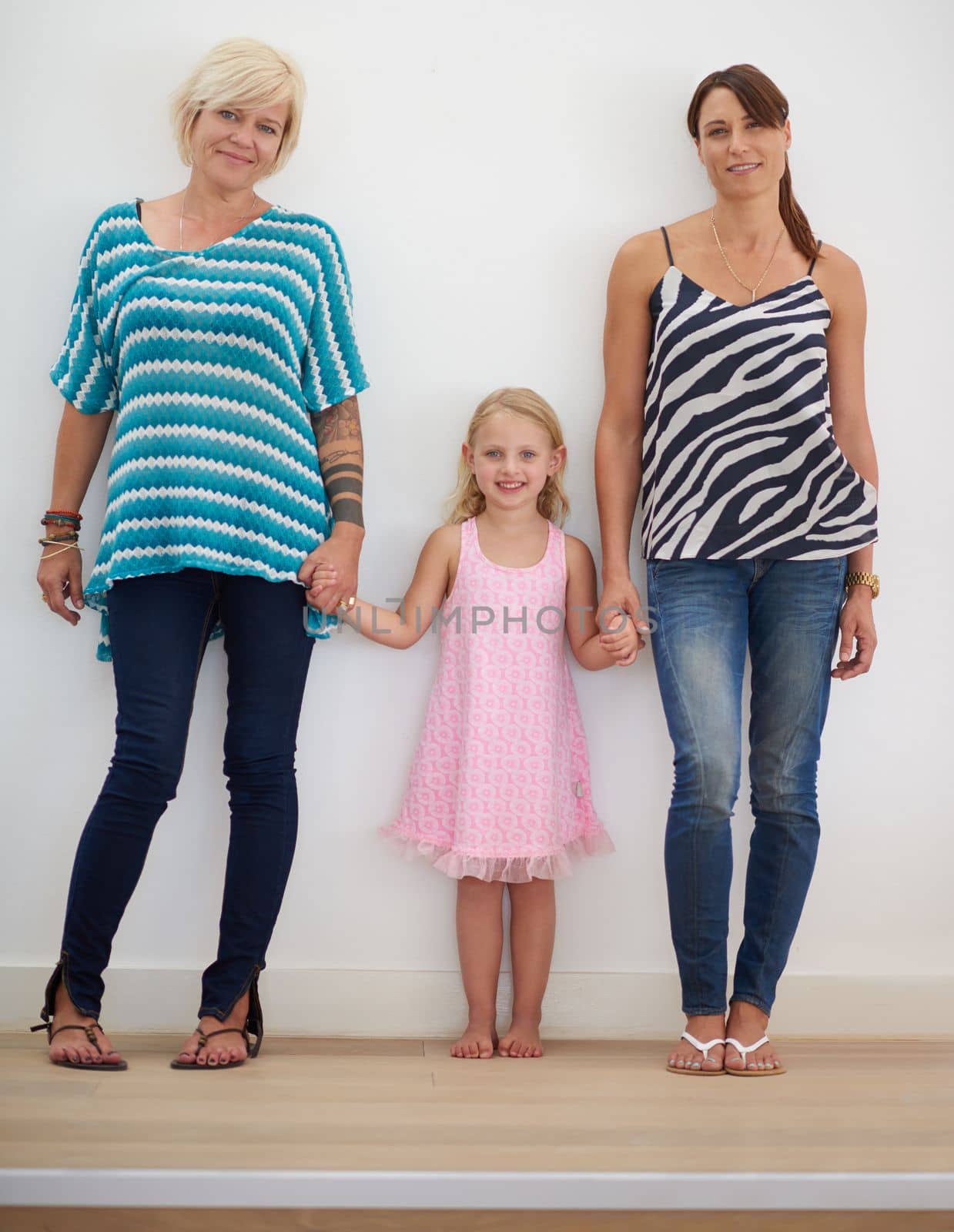 Family is life. a lesbian couple at home with their daughter