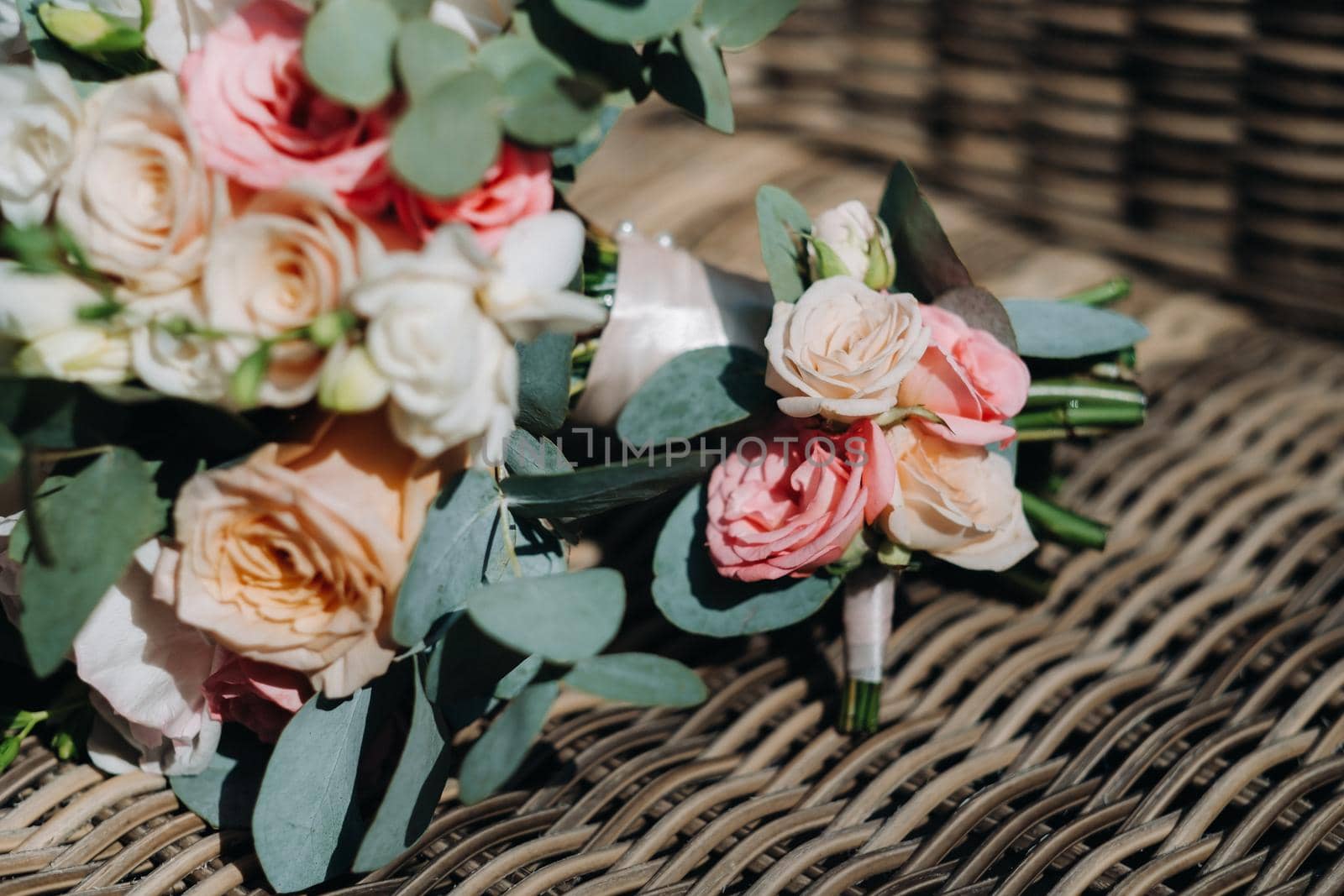 wedding bouquet with peonies and roses on a chair and boutonniere.The decor at the wedding.