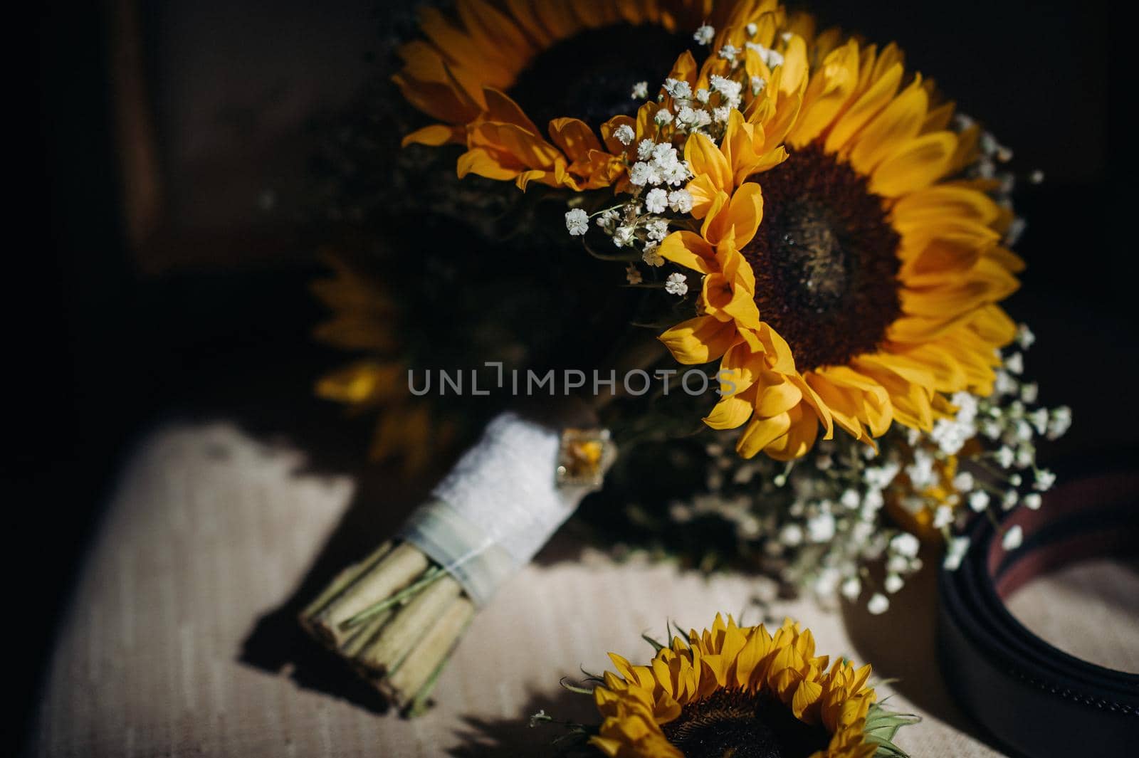 a wedding bouquet of sunflowers lies on an antique chair.Wedding Decor.