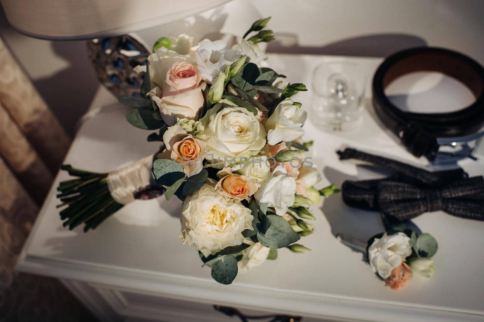 wedding bouquet with roses and boutonniere.The decor at the wedding.