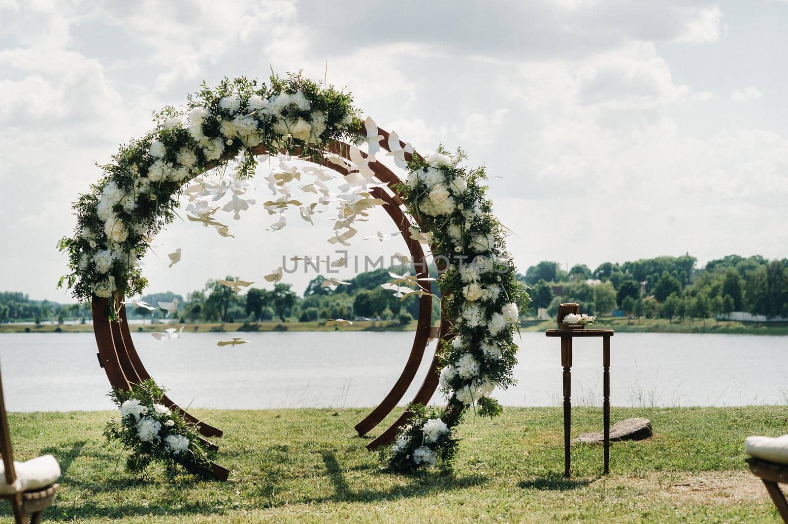 Wedding ceremony on the street on the green lawn.Decor with fresh flowers arches for the ceremony.