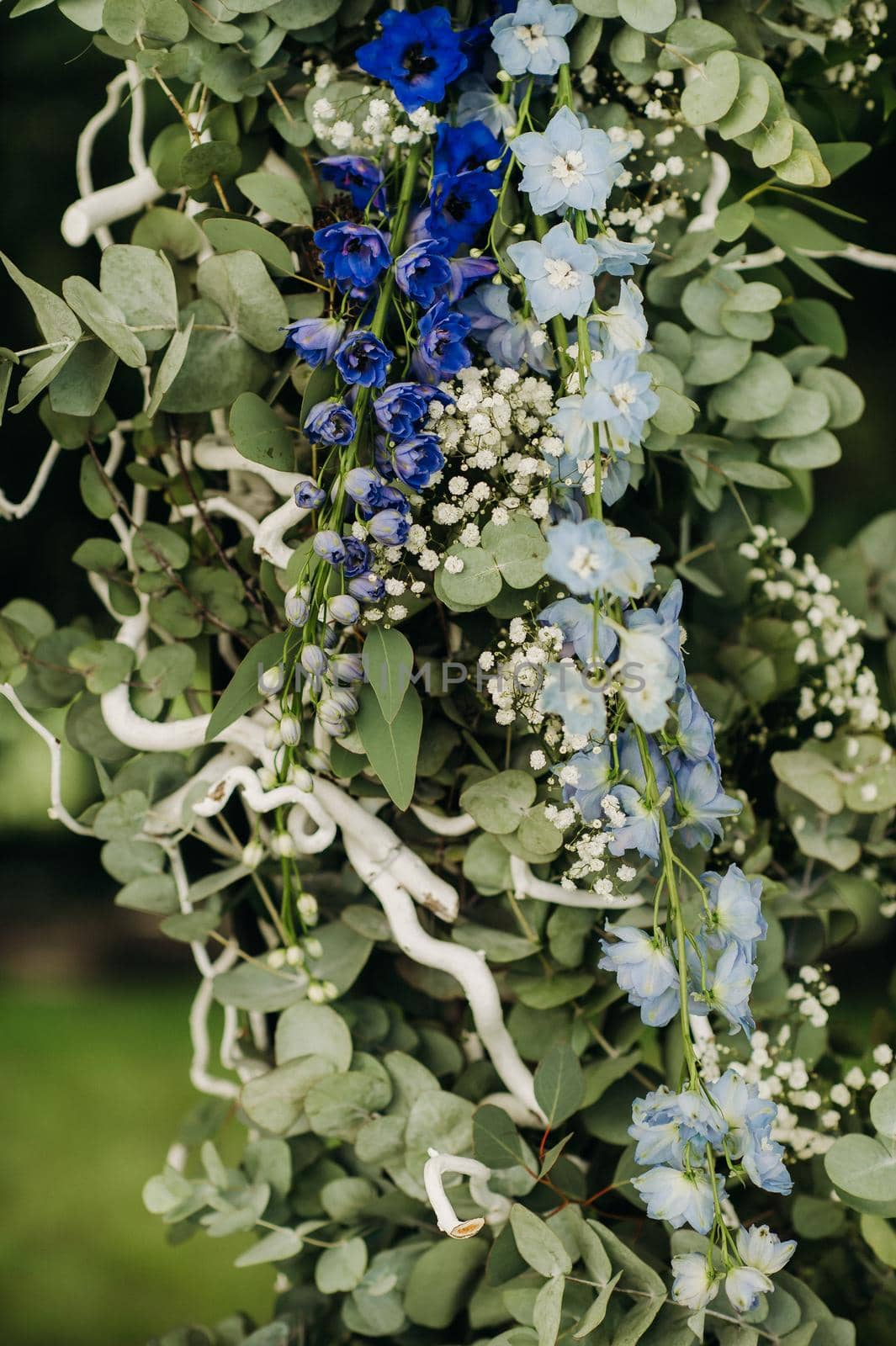 Wedding ceremony on the street on the green lawn.Decor with fresh flowers arches for the ceremony.