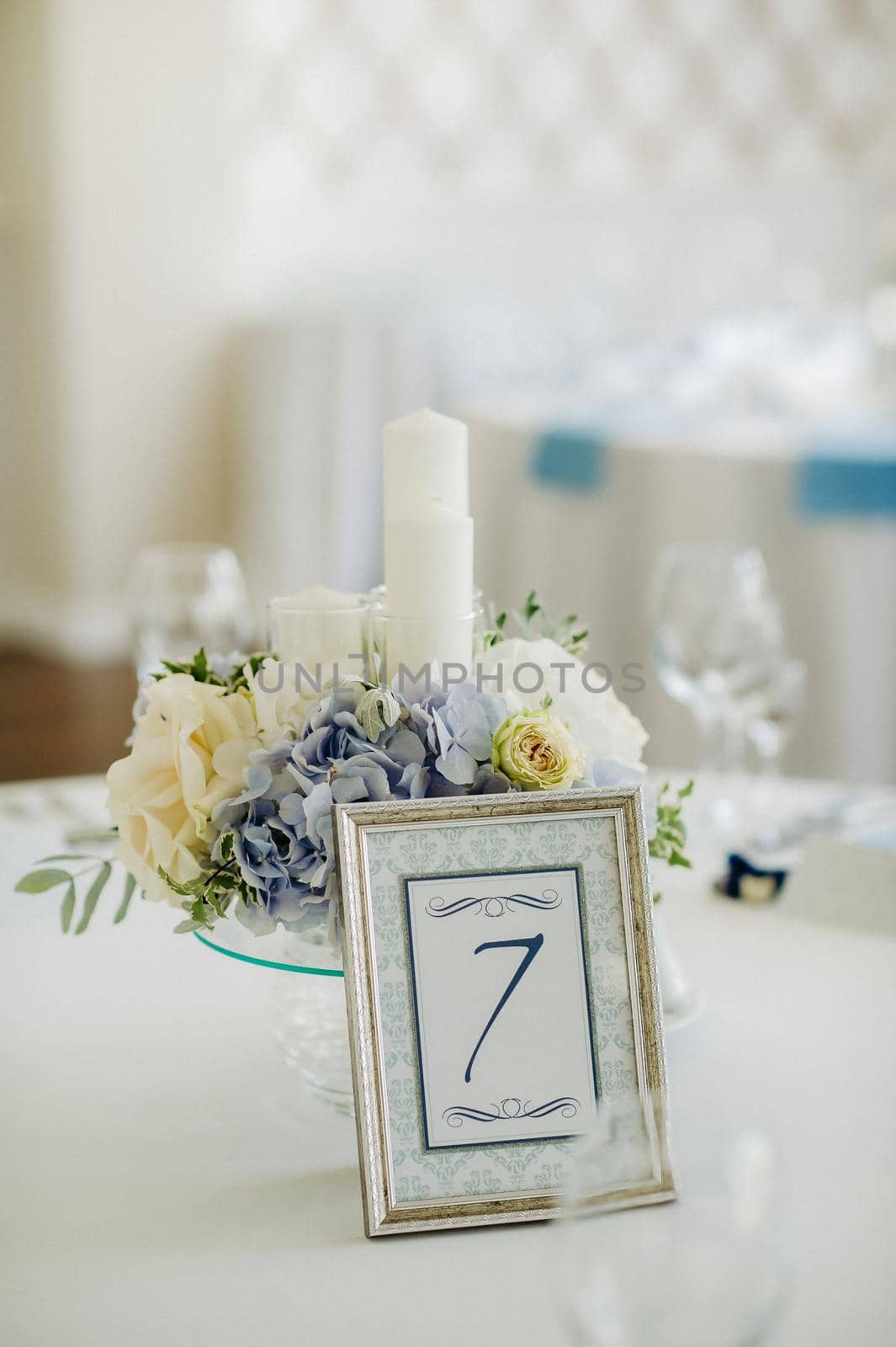 wedding table decoration with blue flowers on the table in the restaurant table decor for dinner at the wedding. by Lobachad