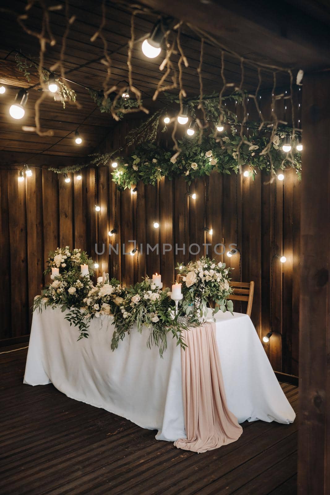 wedding table decoration with flowers on the table in the castle, table decor for dinner by candlelight.Dinner with candles by Lobachad