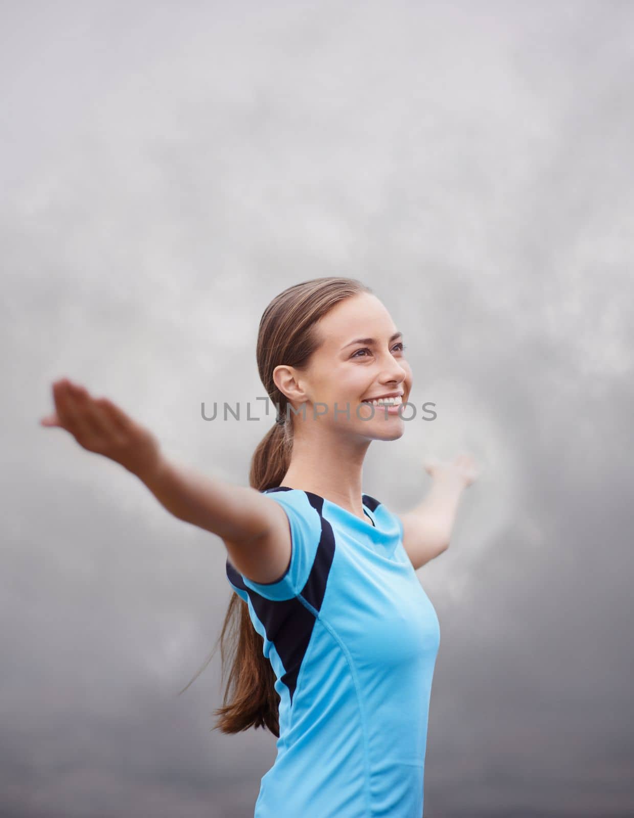 Embracing the morning. a young woman training outdoors with her arms outstretched